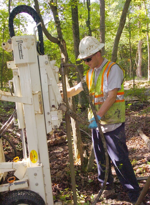 Zachary Boss, an environmental field technician, uses a direct push injection rod to inject KB1 bacteria into the soil at the Brandywine work site eight miles from Andrews. This action is a result of the Andrews Environmental Restoration Program's aggressive cleanup strategy that utilizes bioremediation, which takes advantage of naturally occurring microbes to digest the contaminants and clean the 21-acre groundwater plume.