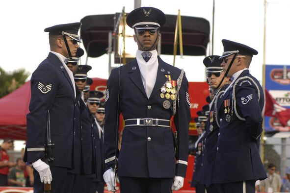 The U.S. Air Force Honor Guard Drill Team performs for racing fans July 5 for the Coke Zero 400 at the Daytona International Speedway in Daytona Beach, Fla. The drill team is the traveling component of the Honor Guard and tours worldwide representing all Airmen while showcasing Air Force precision. (U.S. Air Force photo by Airman 1st Class Sean Adams)