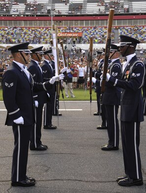 The U.S. Air Force Honor Guard Drill Team performs for racing fans July 5 for the Coke Zero 400 at the Daytona International Speedway in Daytona Beach, Fla. The drill team is the traveling component of the Honor Guard and tours worldwide representing all Airmen while showcasing Air Force precision. (U.S. Air Force photo by Airman 1st Class Sean Adams)