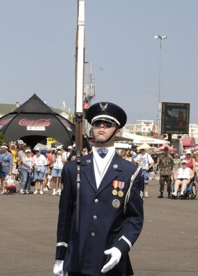 Senior Airman James Cashwell, U.S. Air Force Honor Guard Drill Team, flips his weapon in the air during a performance July 4 at the Daytona International Speedway in Daytona Beach, Fla. The drill team is the traveling component of the Honor Guard and tours worldwide representing all Airmen while showcasing Air Force precision. (U.S. Air Force photo by Airman 1st Class Sean Adams)