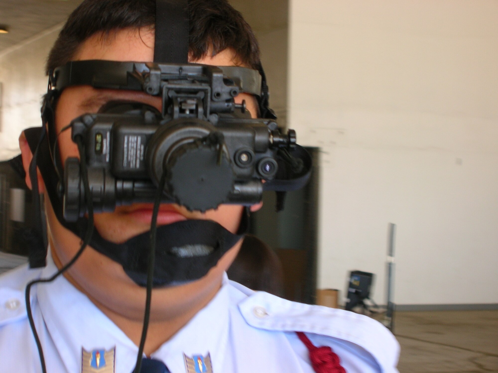 Cadet Technical Sgt. Edward Herrera, 17, of Rancho Verde H.S., takes a look through
a set of night vision goggles during an EOD demonstration at March Air Reserve Base.  (U.S. Air Force photo by Daniel Pilkington)