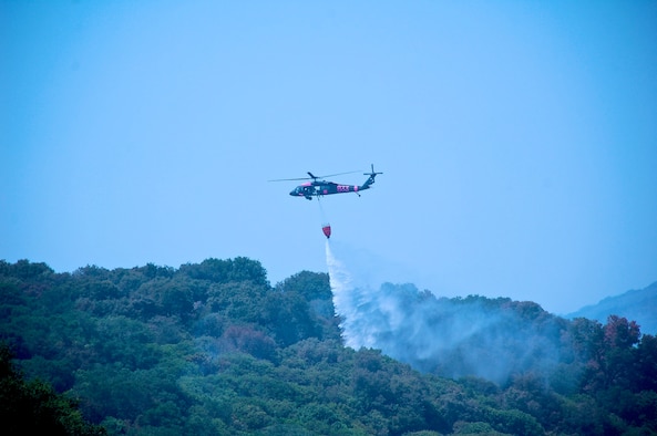 Helicopters from the Army National Guard have worked with the California Department of Forestry and Fire Protection (CALFIRE) for over a week to put out fires that burned over 400,000 acres. (Photo by SGT Stuart Brown, California National Guard) 
