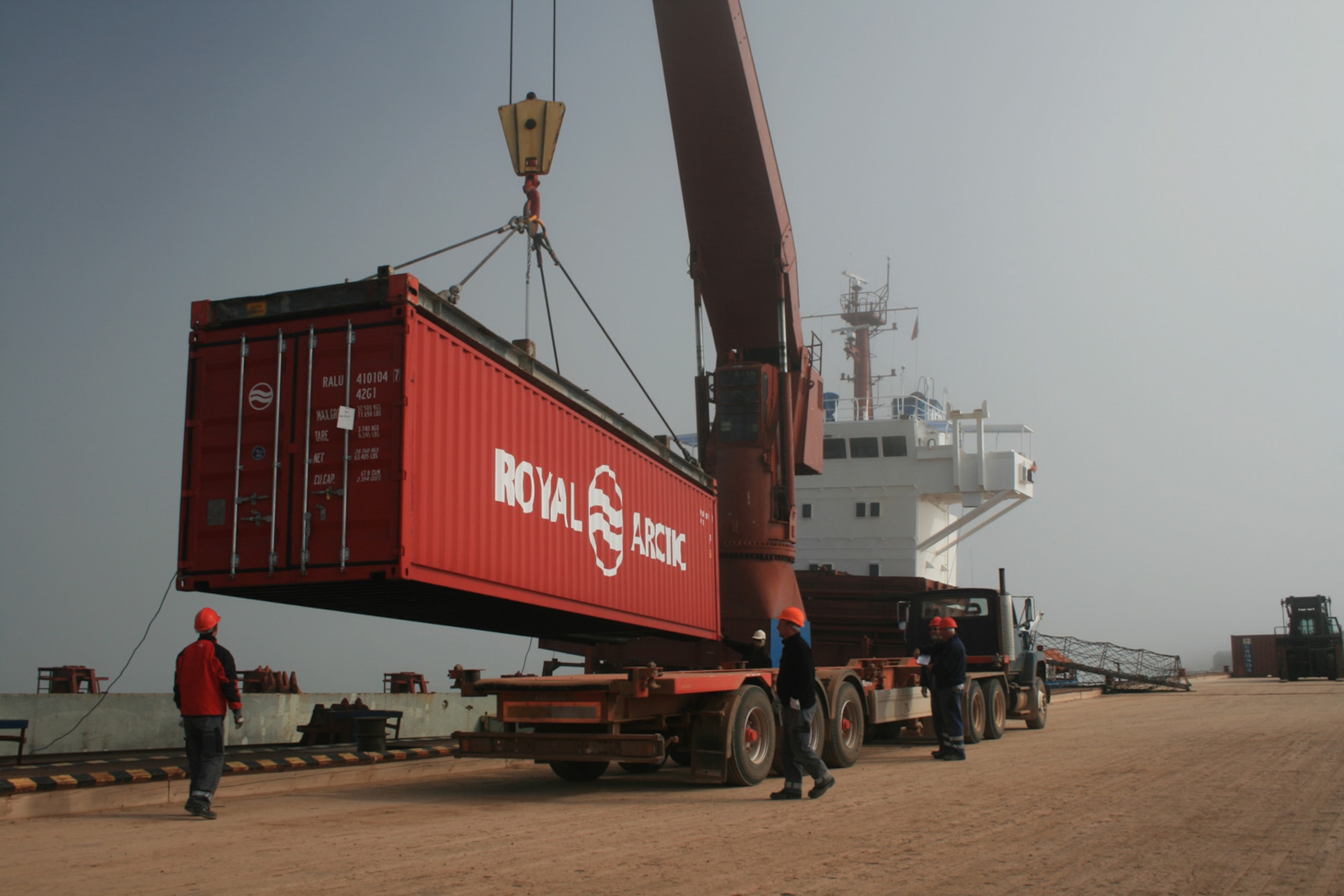THULE AIR BASE, Greenland -- After docking in the world's northernmost deepwater port here June 30, containers are quickly off loaded the Sea Bird cargo ship. In less than 12 hours, the Sea Bird’s 107 cargo containers and flat racks were offloaded and over 1,270 metric tons of cargo was processed.   The arrival of the ship marked the formal opening of the 30-day Arctic port season. (U.S. Air Force photo/Col. Lee-Volker Cox)