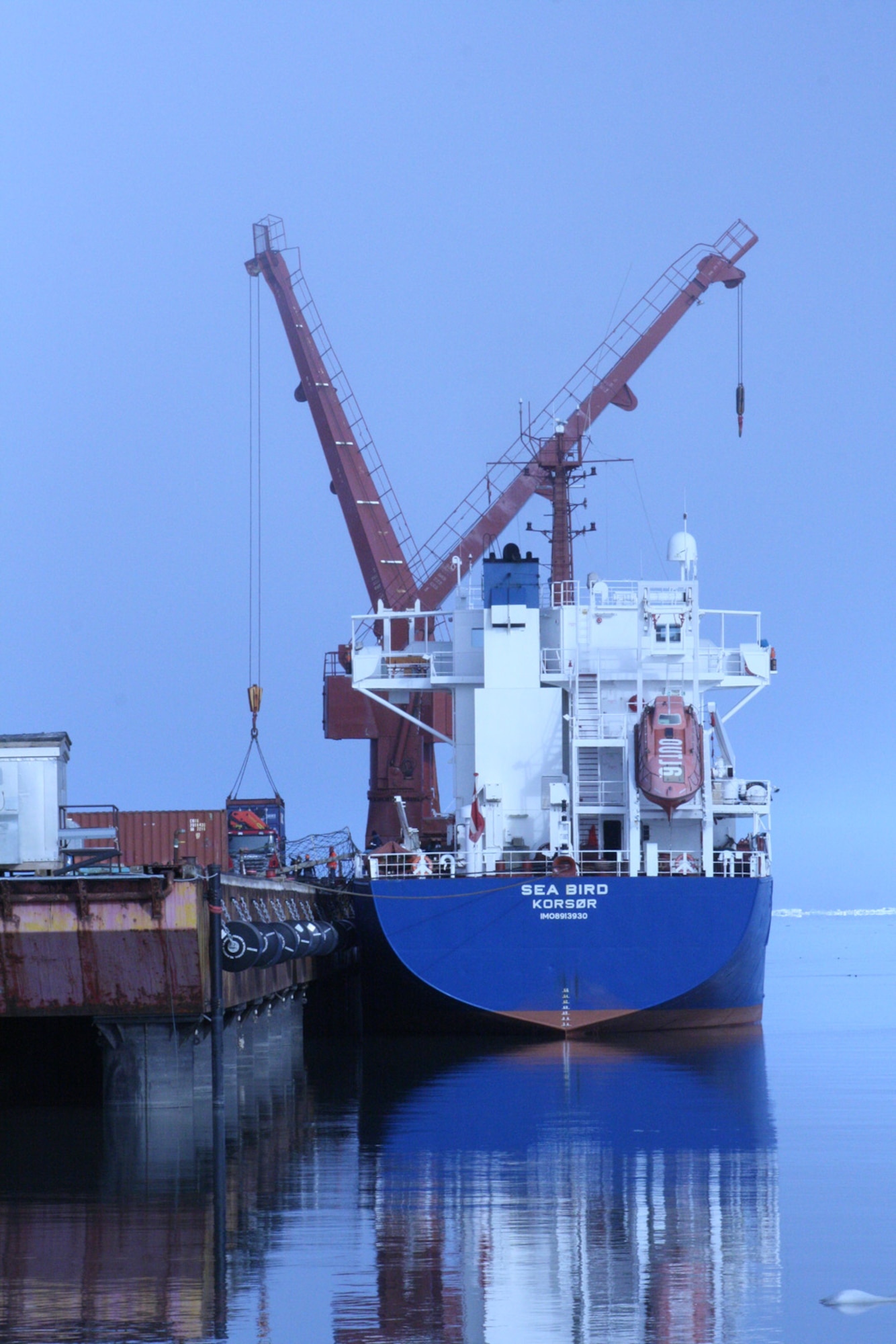 THULE AIR BASE, Greenland -- The Sea Bird cargo ship docks in the world's northernmost deepwater port here June 30. In less than 12 hours, the Sea Bird’s 107 cargo containers and flat racks were offloaded and over 1,270 metric tons of cargo was processed.   The arrival of the ship marked the formal opening of the 30-day Arctic port season. (U.S. Air Force photo/Col. Lee-Volker Cox)