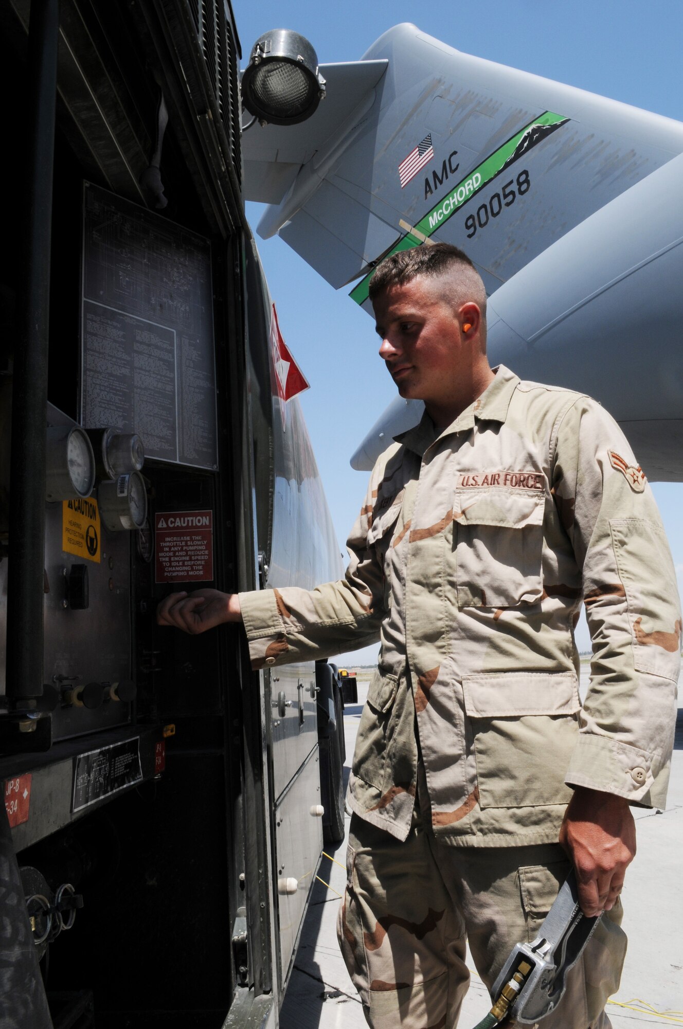 Airman 1st Class Cory Dockery, 376th Expeditionary Logistics Readiness Squadron, fuels distribution operator, fuels a C-17 Globemaster, July 7, 2008, Manas Air Base, Kyrgyz Republic. After completing eight refueling runs in one day, Airman Dockery is fast approaching one million gallons pumped. (Air Force photo by Airman 1st Class Ruth Holcomb)