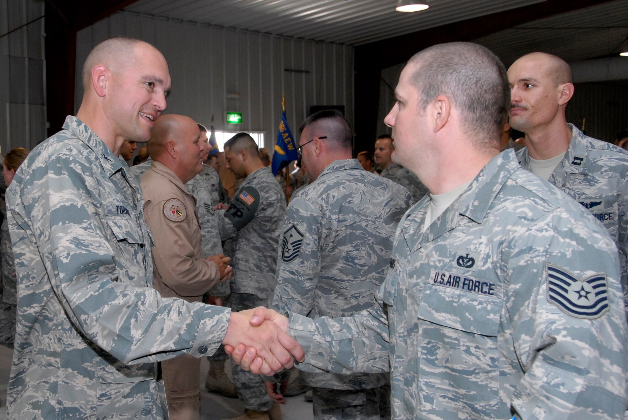SOUTHWEST ASIA -- Colonel Cameron Torrens, 386th Air Expeditionary Wing Commander, shakes hands with his Airmen after assuming command of the 386th AEW from Col. Robert Swisher during a change of command ceremony here July 6, 2008. (U.S. Air Force photo/Staff Sgt. Patrick Dixon)