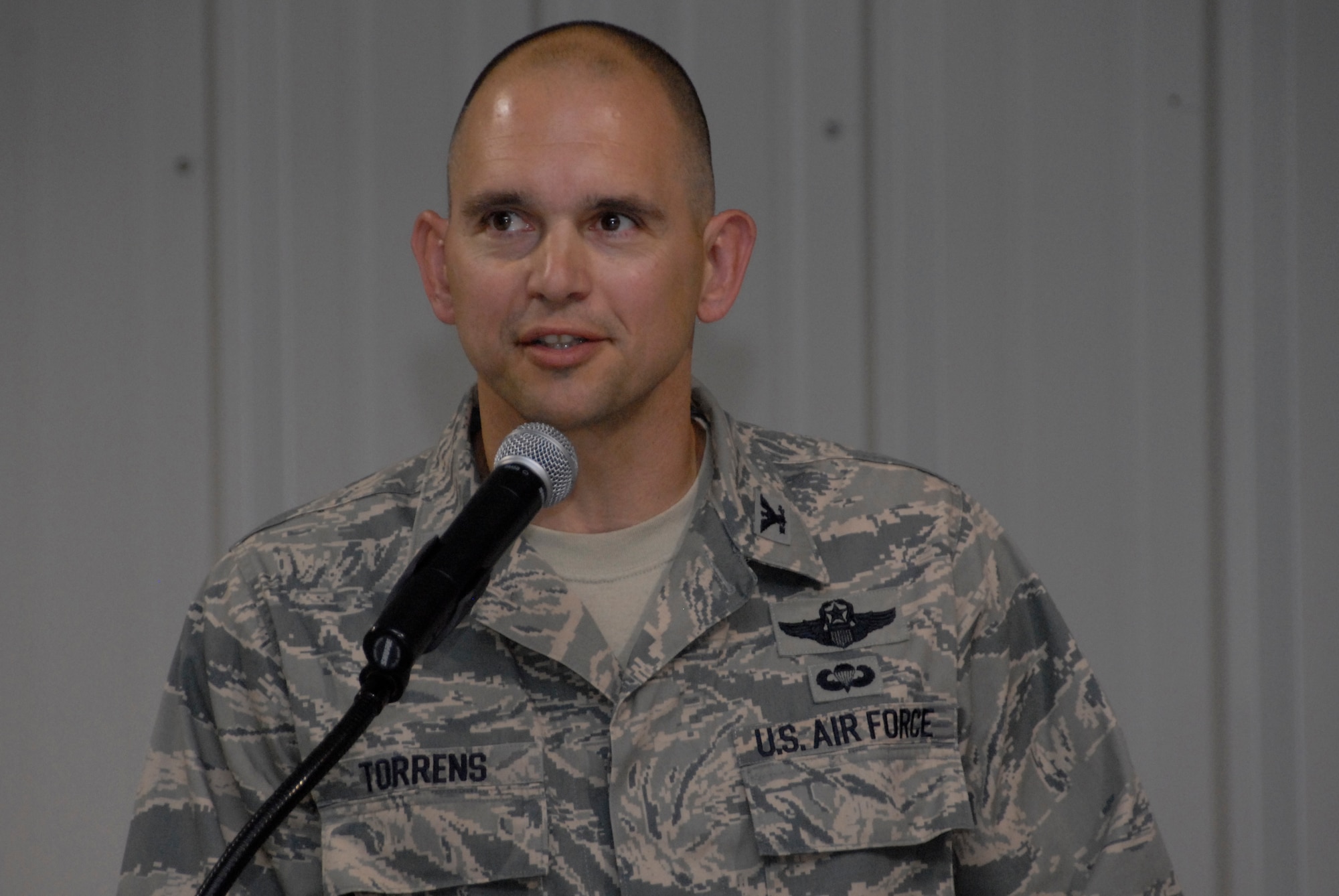 SOUTHWEST ASIA -- Colonel Cameron Torrens, 386th Air Expeditionary Wing commander, talks to nearly 500 distinguished visitors, U.S. and coalition forces, and the Airmen of the 386th after assuming command of the wing from Col. Robert Swisher during a change of command ceremony here July 6, 2008. (U.S. Air Force photo/Staff Sgt. Patrick Dixon)