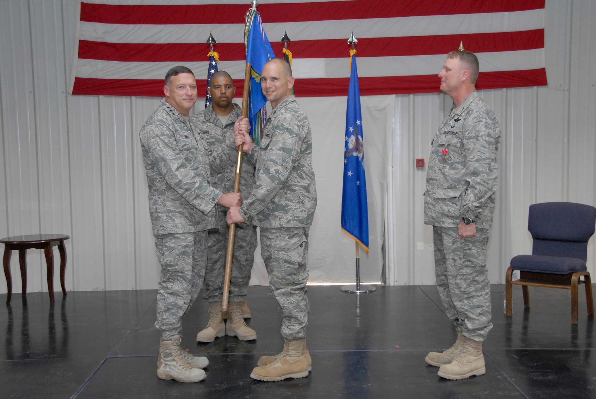 SOUTHWEST ASIA -- Colonel Cameron Torrens accepts the guide-on from Lt. Gen. Gary North, the commander of Ninth Air Force and U.S. Air Forces Central, as he assumes command of the 386th Air Expeditionary Wing from Col. Robert Swisher during a change of command ceremony here July 6, 2008. (U.S. Air Force photo/Staff Sgt. Patrick Dixon)