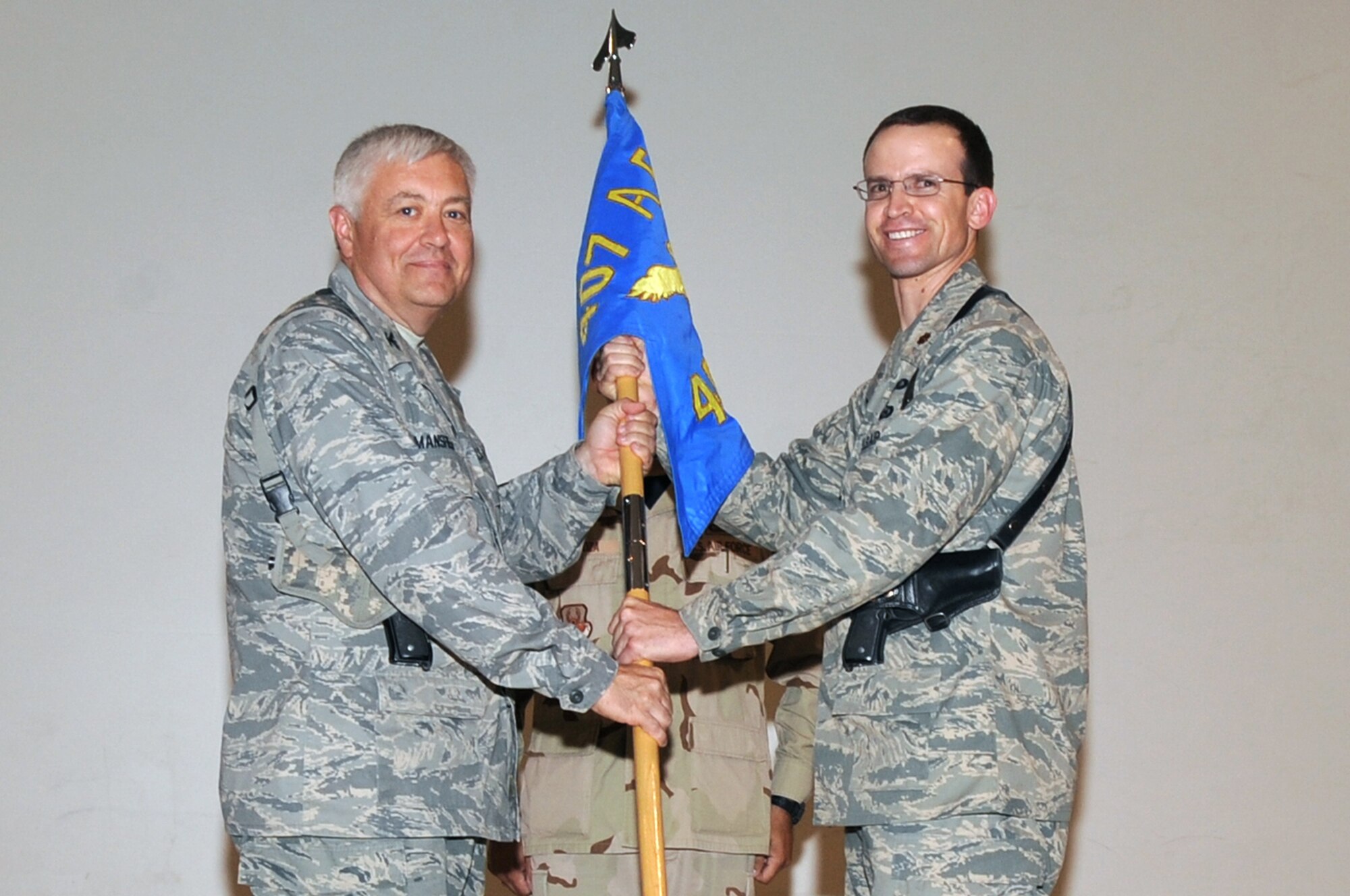 ALI BASE, Iraq -- Major Richard McKee assumes command of the 407th Expeditionary Force Support Squadron by accepting the guidon from Colonel David Mansfield, 407th Air Expeditionary Group commander, during a change of command ceremony here, July 1. Major McKee is taking command of the 407th EFSS due to a recent merger of the 407th Expeditionary Services Squadron and customer service related offices within the 407th Air Expeditionary Group. (U.S. Air Force photo/Tech. Sgt. Sabrina Johnson)