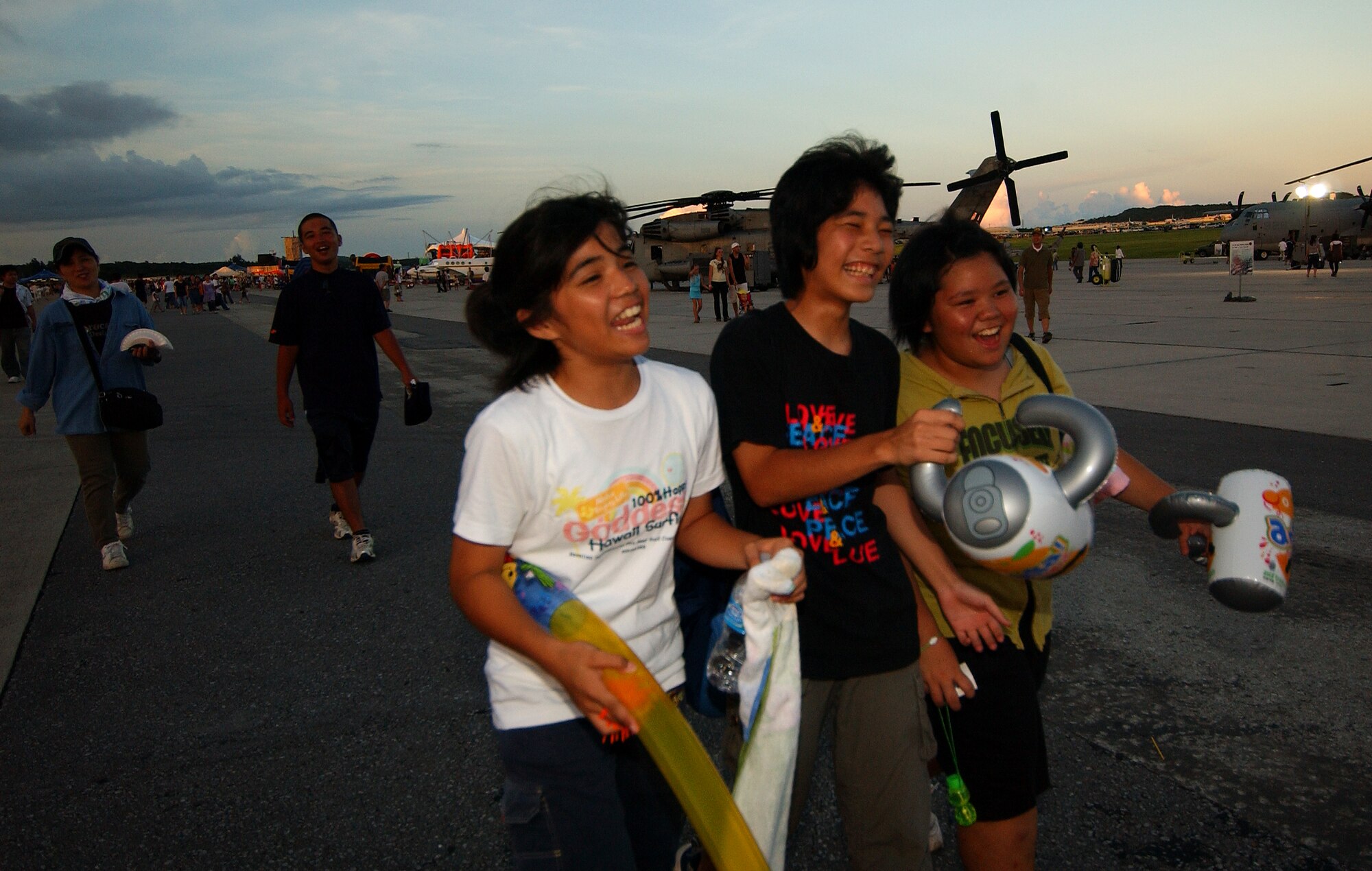 A few young local nationals sing songs as they depart from Kadena Air Base’s AmericaFest open house July 5, 2008.  AmericaFest featured two dozen aircraft static displays, live entertainment, activities for children and a nightly fireworks show. The two-day event, which was designed to strengthen relations with the base's Okinawan neighbors, drew nearly 66,000 people.
(U.S. Air Force photo/Tech. Sgt. Rey Ramon)