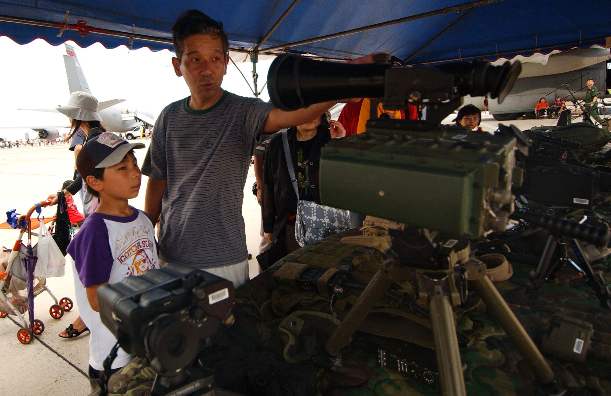 Makino Katsushi and his son, Kaito, 9, get an up-close look at equipment used by the 320th Special Tactics Squadron during Kadena Air Base’s AmericaFest open house July 5, 2008. AmericaFest featured two dozen aircraft static displays, live entertainment, activities for children, and a nightly fireworks show. The two-day event, which was designed to strengthen relations with the base’s Okinawan neighbors, drew nearly 66,000 people. 
(U.S. Air Force photo/Tech. Sgt. Rey Ramon)    