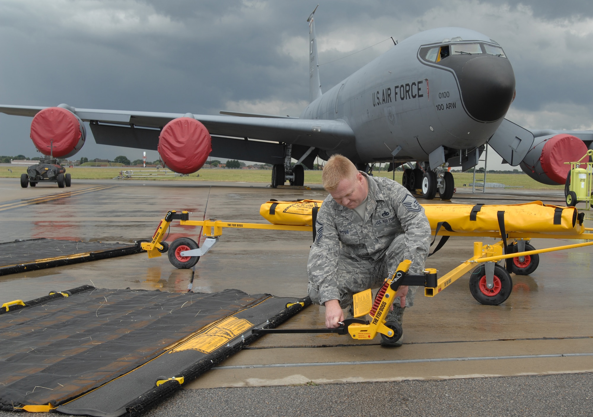 Master Sgt. James Rose, 100th Air Refueling Wing FOD and Dropped Object Prevention Program monitor, locks down the arms of a FOD sweeper at RAF Mildenhall. The 24-foot wide sweepers augment regular FOD walks, picking up objects Airmen might overlook. This AFSO21 initiative will save more than 13,000 work hours a year.