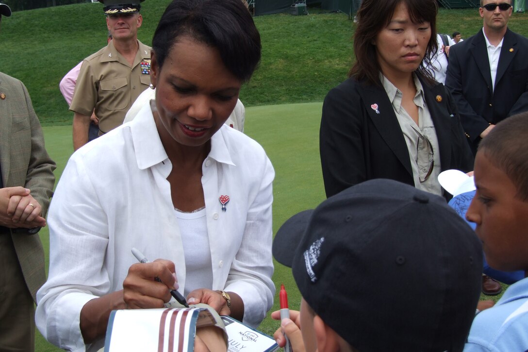 Sporting an "Amercia Supports You" lapel pin, Secretary of State Condoleezza Rice signs autographs at the AT&T National Golf Tournament, July 5, 2008, in Bethesda, Md. "America Supports You" is a Defense Department's program that highlights public support for the troops.