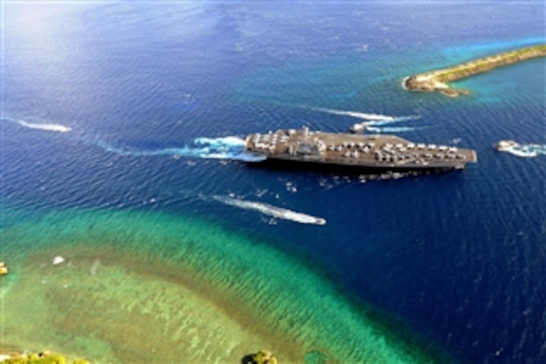The aircraft carrier USS Ronald Regan and Carrier Air Wing 14 begin their transit into Agana Harbor for a port call on Guam after working off the coast of the Philippines in the wake of Typhoon Fengshen, July 6, 2008. The Ronald Reagan Carrier Strike Group is on a routine deployment in the 7th Fleet area of responsibility. 