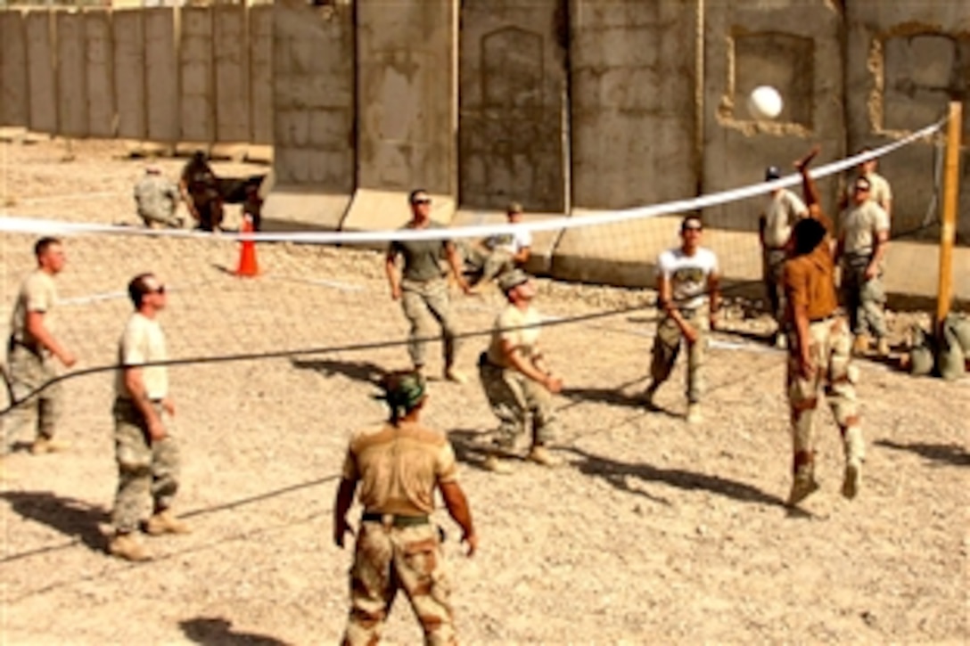 Iraqi soldiers compete against U.S. Weapons Platoon, Company B, 1st Battalion, 27th Infantry Regiment in a volleyball tournament during the Borzoi Squad Competition at Joint Security Station Sheik Amir, northwest of Baghdad, Iraq, July 4, 2008. 