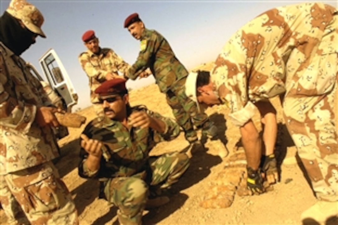 Iraqi soldiers prepare to destroy confiscated ordinance at a demolition range outside of Camp Echo, Iraq, July 4, 2008.  
