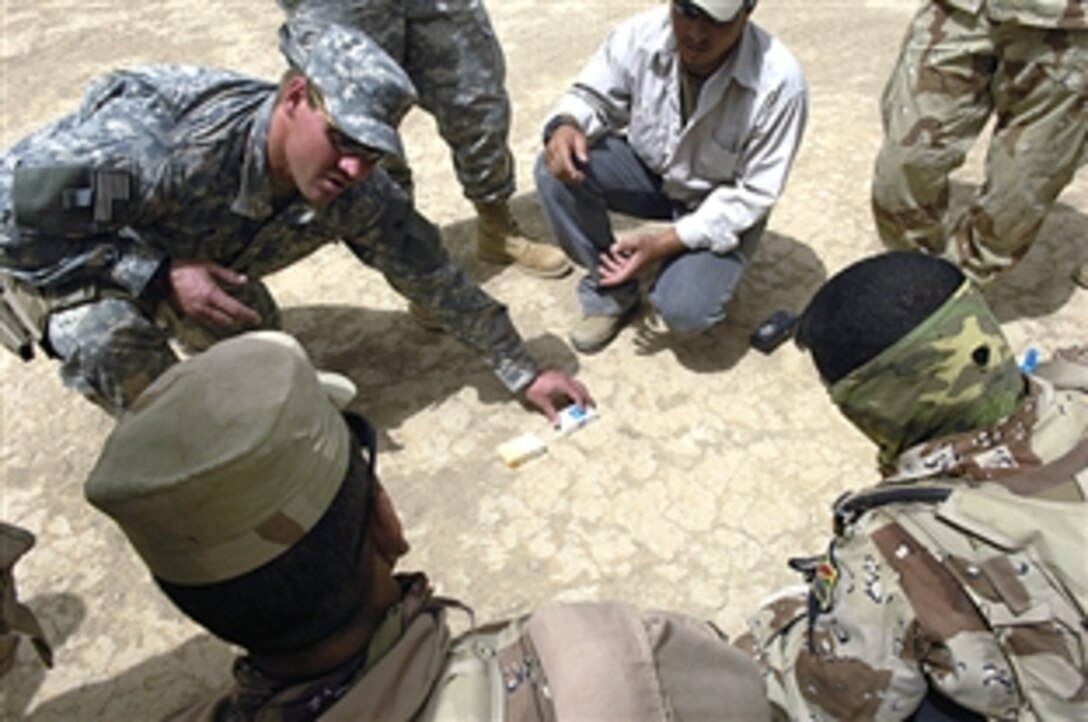 U.S. and Iraqi soldiers gather for a review after conducting a training exercise on reacting to improvised explosive devices, Camp Echo, Iraq, July 2, 2008. The U.S. soldiers are assigned to Operational Detachment Alpha team 0326. 
