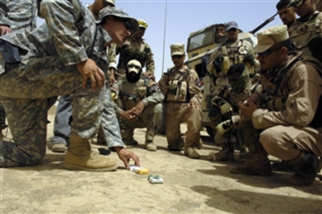U.S. and Iraqi soldiers gather around for an after-action review following an improvised explosive device reaction training exercise at Camp Echo, Iraq, on July 2, 2008.  The U.S. soldiers are from Operational Detachment Alpha, Team 0326 and the Iraqi soldiers are from the 8th Division Iraqi Army.  