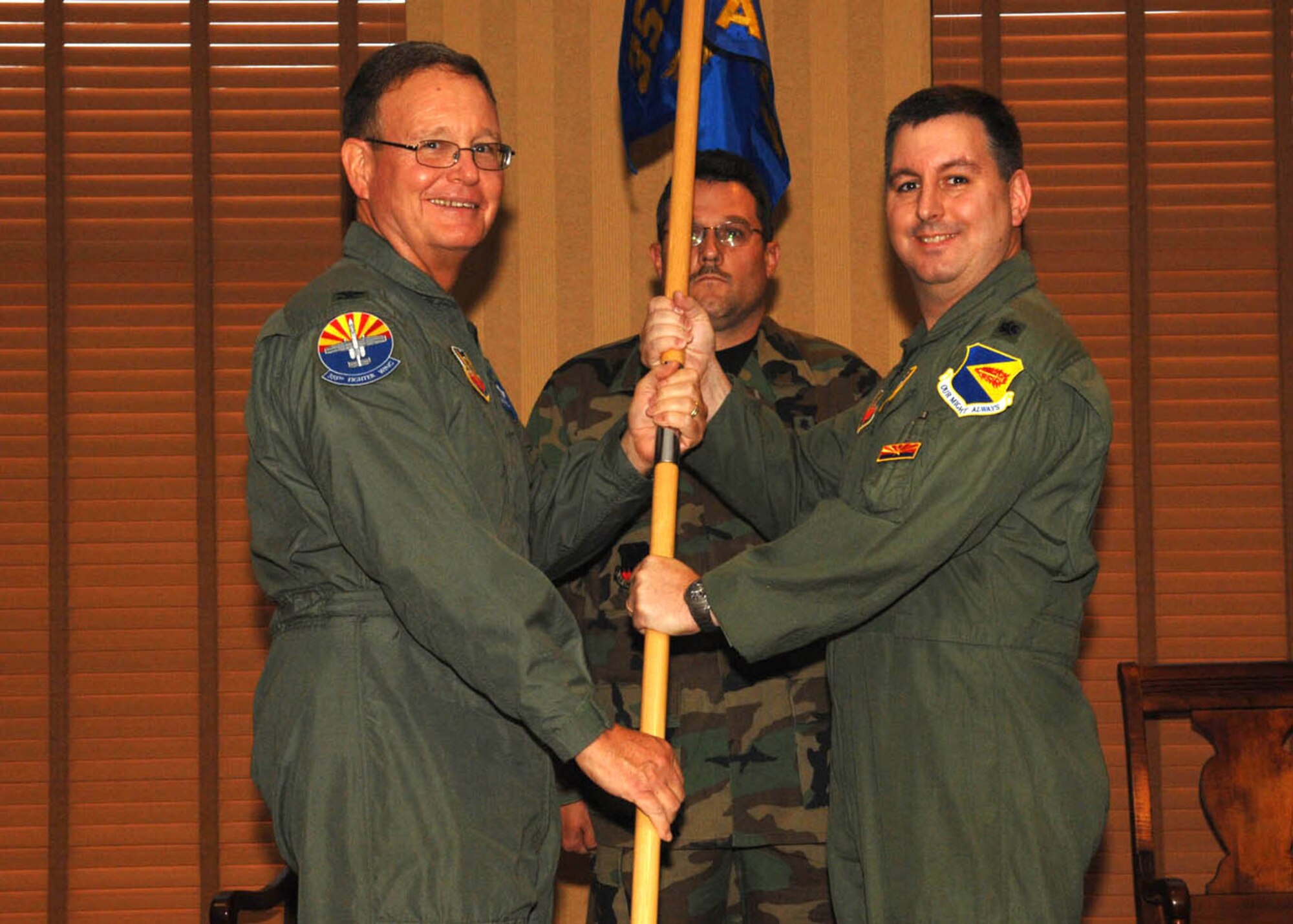 Lt. Col. Michael Wood receives the 355th Aerospace Medicine Squadron guidon from Col. William Pollan, 355th Medical Group commander during a change-of-command ceremony here June 18.  Colonel Wood assumed command of the 355th AMDS after holding the position of chief of aerospace medicine for the 355th AMDS.   (U.S. Air Force photo by Senior Airman Alesia Goosic)