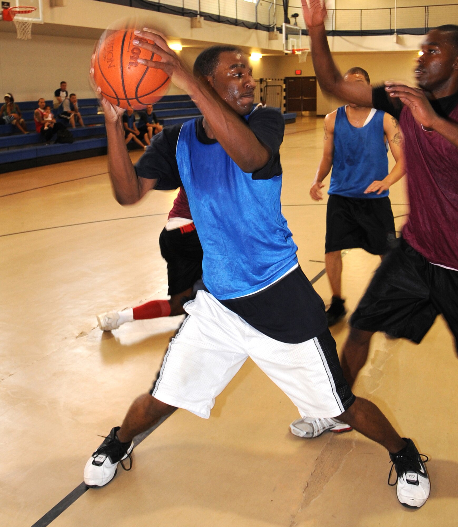7/03/2008 - Airman 1st Class Sean Cooper, 49th Force Support Squadron, looks for an open man while 2nd Lt. Brandon Sanders, 49th Civil Engineer Squadron, plays defense during a basketball game in the base fitness center July 3 at Holloman Air Force Base, N.M. The basketball tournament was hosted by the 49th FSS as a way of celebrating Independence Day. (U.S. Air Force photo/Staff Sergeant Chris Flahive)