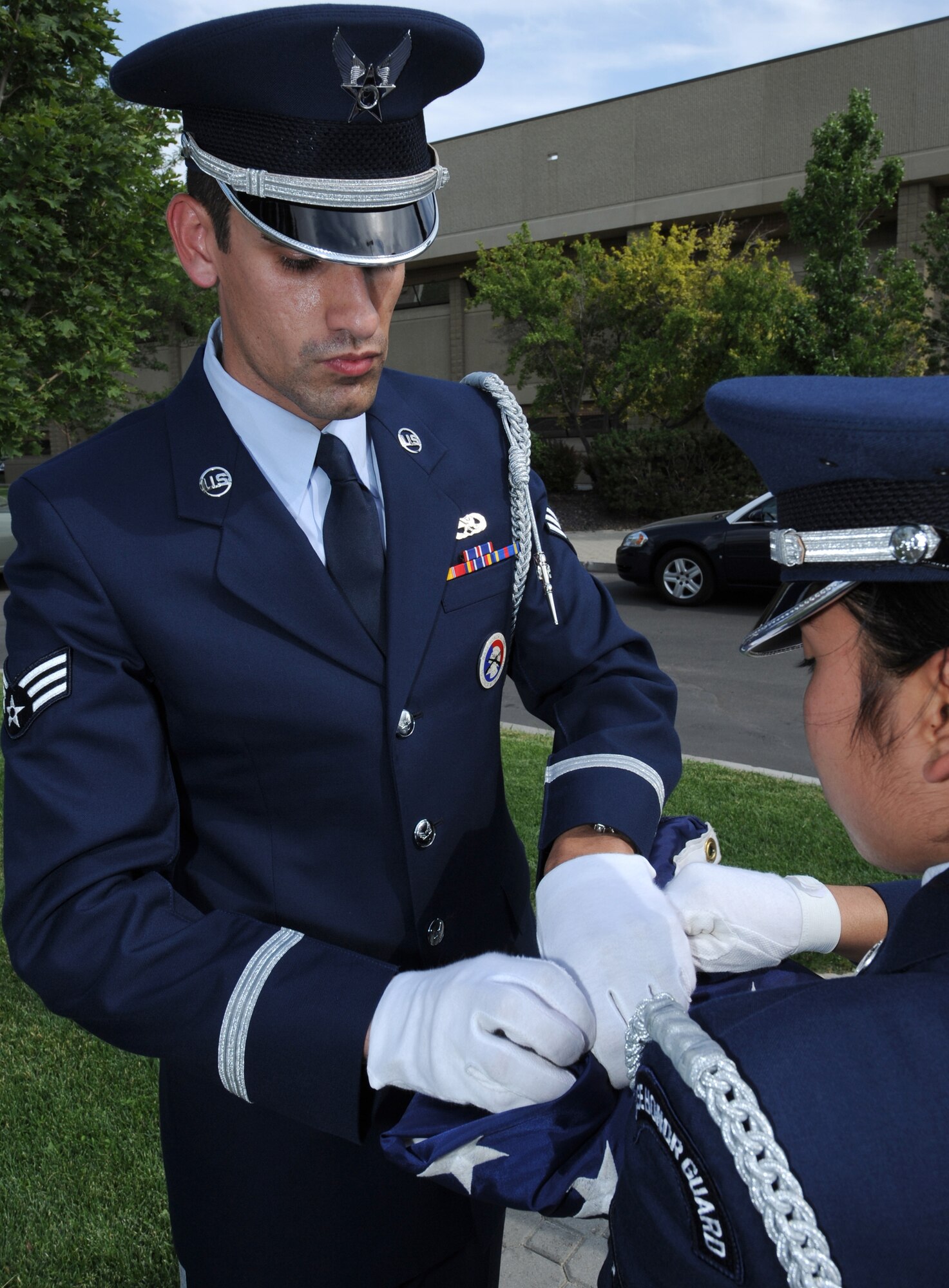 MOUNTAIN HOME AIR FORCE BASE, Idaho - Senior Airman Cindy DeLeon (right), 366th Component Maintenance Squadron honor guard member, and Senior Airman Mark Ellis, 366th Communications Squadron honor guard member, fold the American flag at the 366th Fighter Wing formal retreat July 1. The base honor guard performs many functions around the base to support the wing. (U.S. Air Force photo/ Airman 1st Class Stephany Miller)