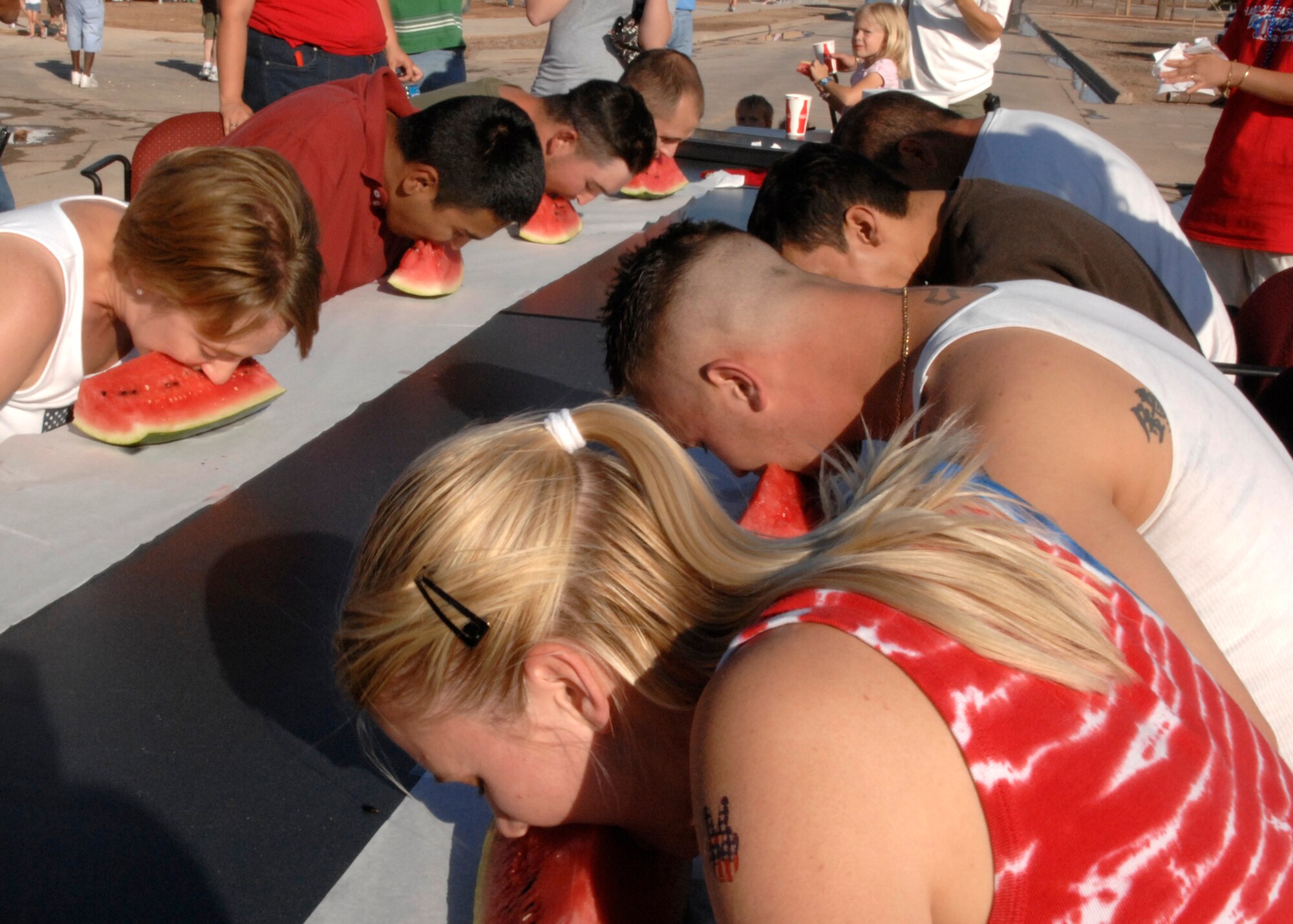 Team Holloman contestants participate in a watermelon eating contest, July 3 at the Old Fashion Independence Day celebration at Holloman Air Force Base, N.M. The celebration included contests, games and a fireworks show to end the celebration. (U.S. Air Force photo/Airman 1st Class Rachel A. Kocin)