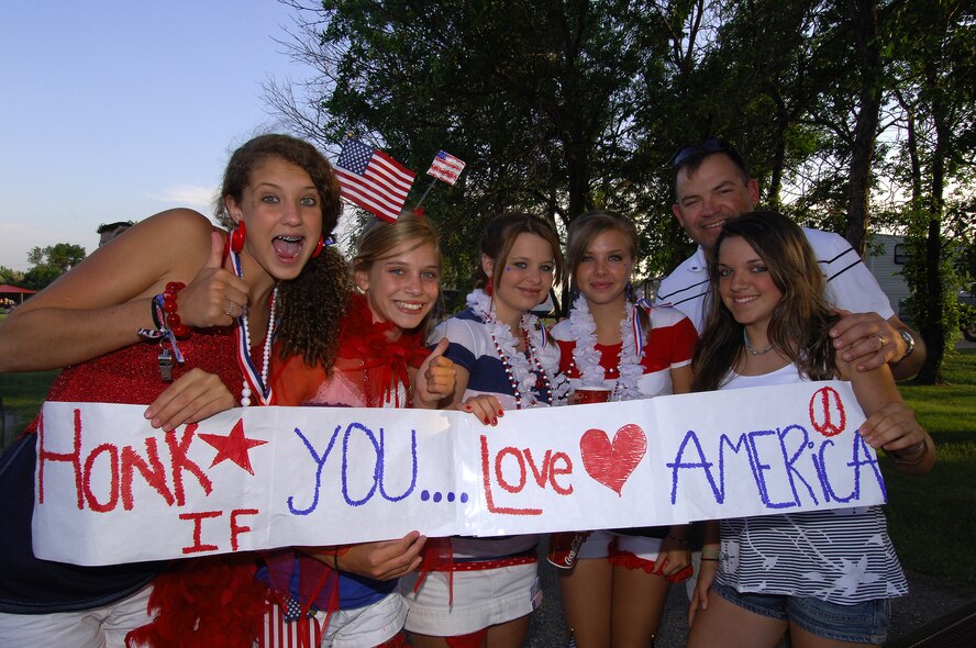 MINOT AIR FORCE BASE, N.D. -- Col. Christopher Ayres, 91st Missile Wing commander, and his eldest daughter, Julia, pose with a group of young ladies displaying their American pride at the base picnic here July 4. Minot Air Force Base’s annual Fourth of July picnic and fireworks display went off with a bang, highlighted by a spectacular fireworks display. The event was hosted by Community Center and 5th Force Support Squadron, which provided fun and entertainment for base residents. (U.S. Air Force photo by Senior Airman Kelly Timney)
