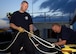 Members from the O'Fallon, Ill., fire department work the ropes as a fellow O'Fallon firefighter repels down the side of the training building on June 3, 2008 at 01:35 Zulu on Scott Air Force Base. Illinois. The O'Fallon fire department was participating in a training exercise with members from the Scott AFB 375th Civil Engineering Squadron Fire Department. (U.S. Air Force photo by Airman 1st Class Wesley Farnsworth) (RELEASED)