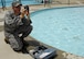 Airman 1st Class Anthony Maffia, 375th Civil Engineer Squadron utility system journeyman, takes samples from the fitness center community pool at Scott Air Force Base Ill. to check the chlorine and PH levels on June 3, 2008 at 18:00 Zulu. The tests are performed three times a day, seven days a week to ensure the safety of the public. (U.S. Air Force photo by Senior Airman Mildred Guevara) (RELEASED)