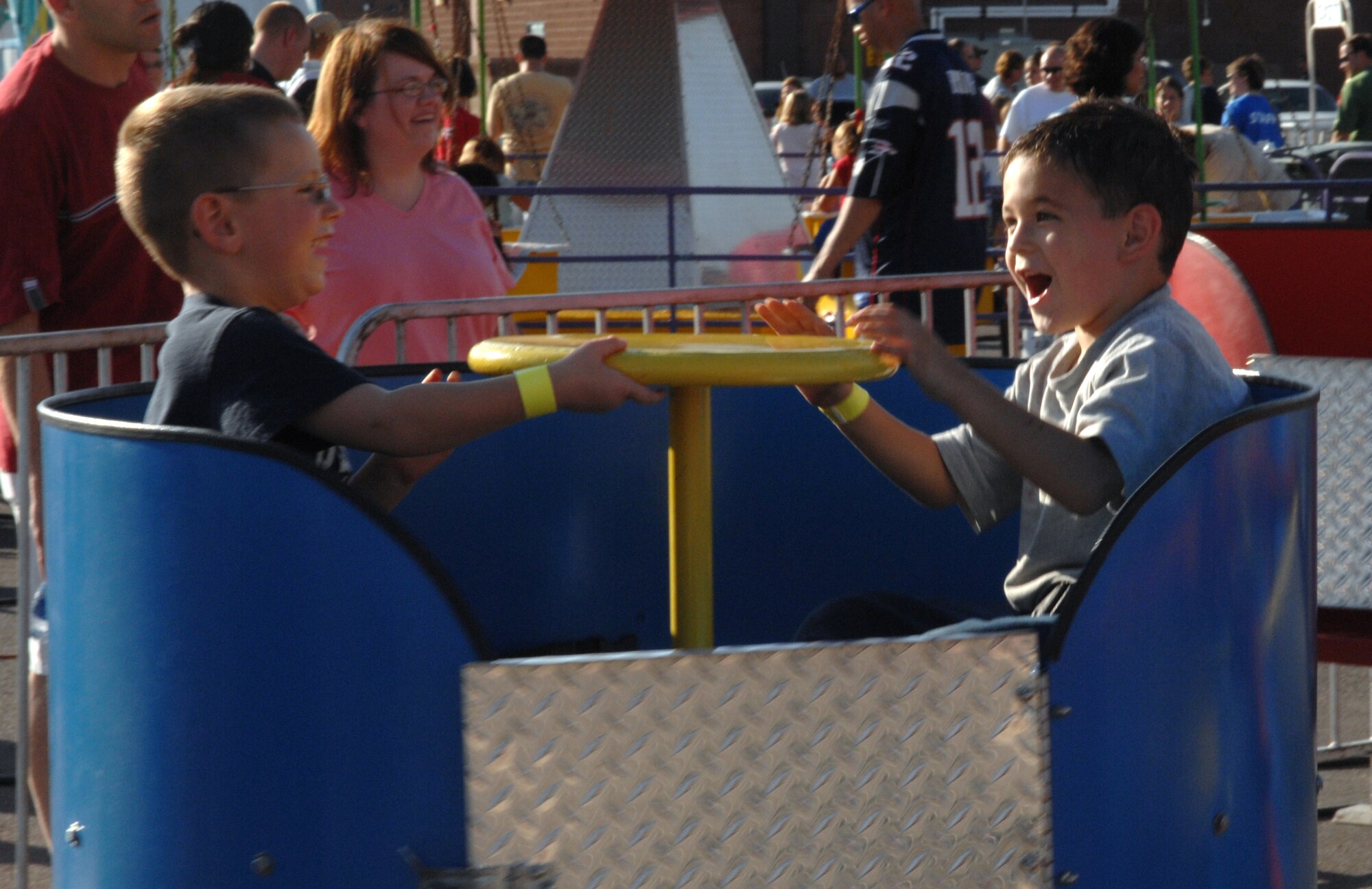 Children of Team Holloman ride on one of the many carnival rides at the Old Fashioned Independance Day celebration at Holloman Air Force Base, N.M., July 3. The celebration included many festivities along with the carnival such as contests, a car show, a live band and free food and drinks.