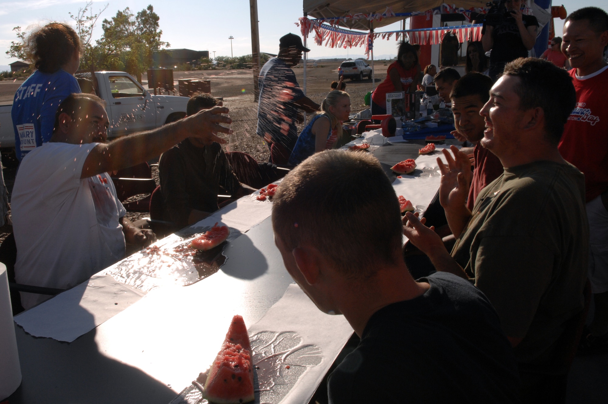 Members of Team Holloman get into a watermelon fight after a watermelon eating contest at the Old Fashioned Independance Day celebration at Holloman Air Force Base, N.M., July 3. The contest was one of many along with a frozen t-shirt contest, Texas hold-em contest and musical chair scavenger hunt.