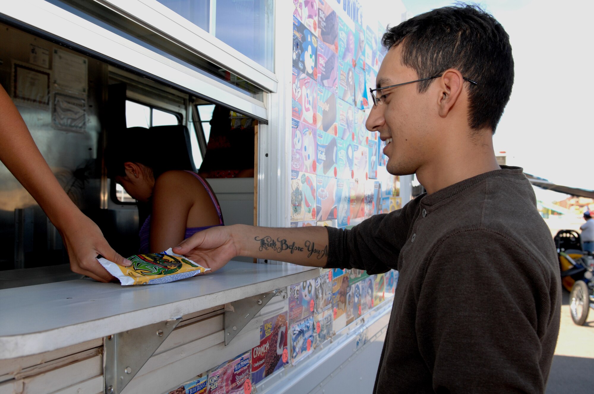 Airman 1st Class David Escutia-Lopez, 49th Force Support Squadron, purchases ice cream from a vendor at the Old Fashion Indepedance Day celebration at Holloman Air Force Base, N.M., July 3. More than 3,000 members of Team Holloman attended the celebration that ended later that night with fireworks.