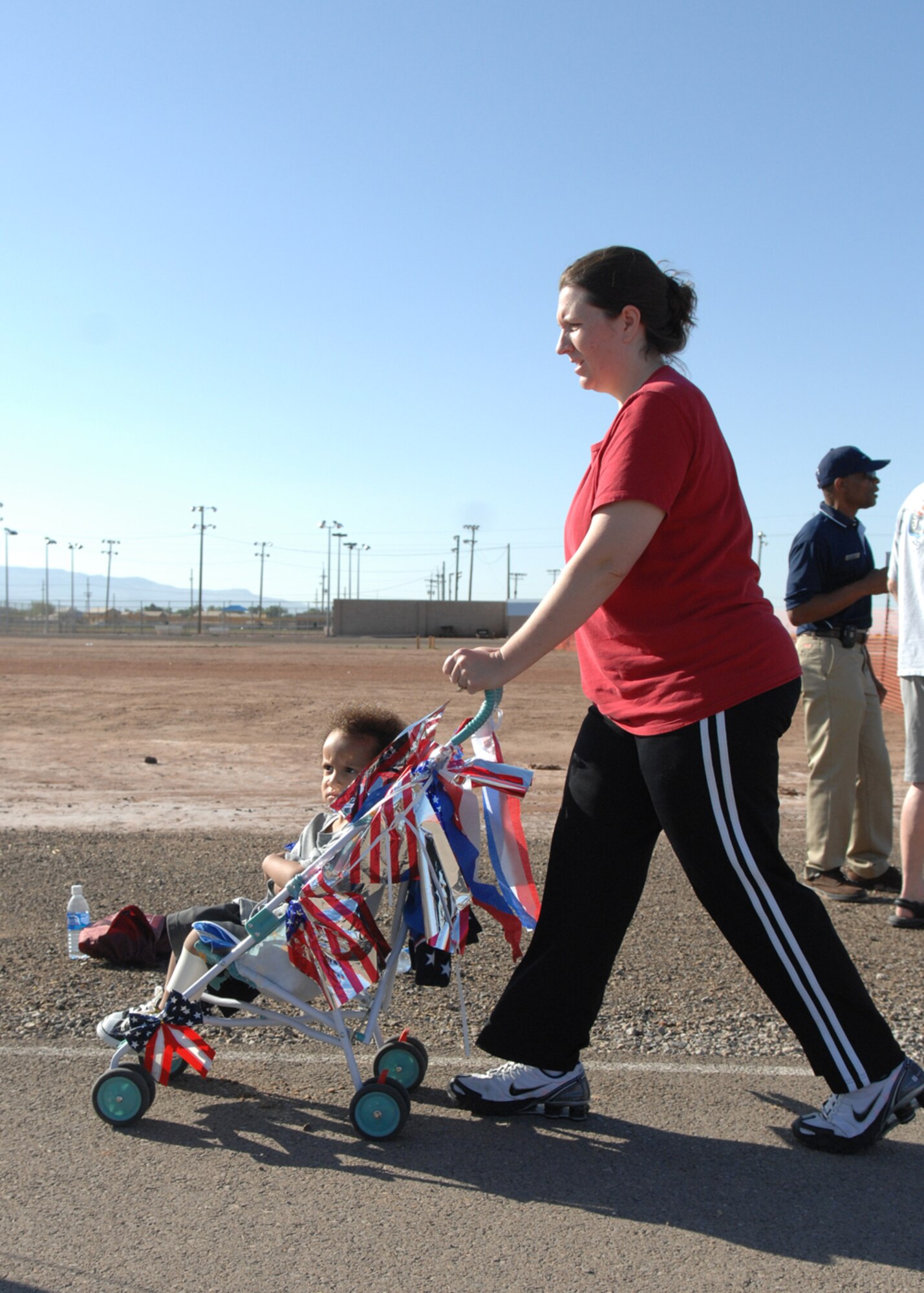 A Member of Team Holloman walks around the track with a patriotically decked out stroller during the four mile Freedom Fest Fun Run, hosted by the 49th Force Support Squadron July 3 at Holloman Air Force Base, N.M. Holloman hosted the Freedom Fest Fun Run and other events as a way of celebrating Independence Day.


(U.S. Air Force photo/Senior Airman Anthony Nelson Jr)
