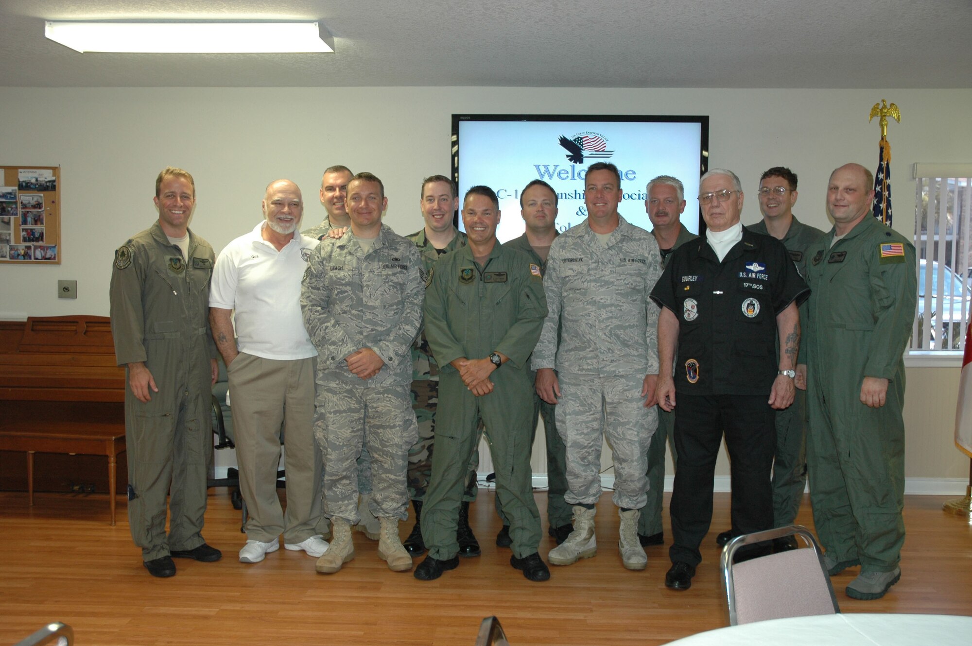 Members of the 18th Flight Test Squadron at Hurlburt Field stand with Gus Sininger (second from left) and Garrettson "Garry" Gourley (front row, second from right) after a ceremony to dedicate two AC-119 gunship lithographs to Teresa Village on July 8. Sininger and Gourley are retired flight engineers on the K-model and G-model, respectively. The original paintings, by Darby Perrin, were donated to the United States Air Force Museum by the AC-119 Gunship Association. The paintings detail the highly dangerous missions flown by the aircrews of the 71st, 17th and 18th Special Operations Squadrons during the Vietnam conflict beginning in 1969. The 18th FLTS has a direct lineage to the 71st, 17th and 18th SOSs. (U.S. Air Force photo by Master Sgt. Buffy Galbraith)
