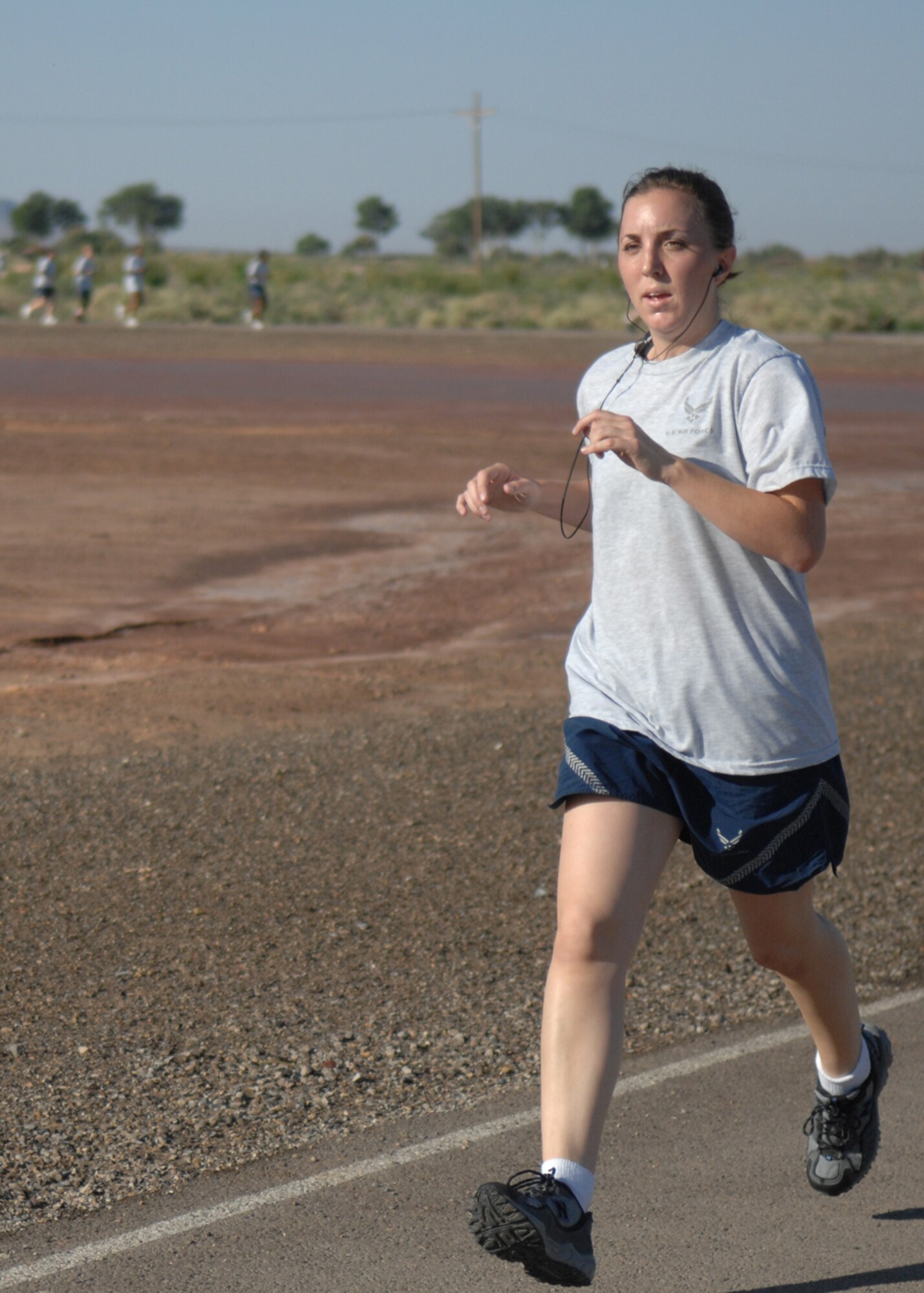 Airman 1st Class Rachel Kocin listens to music while she paces herself during the four mile Freedom Fest Fun Run, hosted by the 49th Force Support Squadron July 3 at Holloman Air Force Base, N.M. Airman Kocin is a
photographer assigned to the 49th Fighter Wing Public Affairs office. Holloman AFB hosted the 5K Freedom Fest Fun Run and other events as a way of celebrating Independence Day.

(U.S. Air Force photo/Senior Airman Anthony Nelson Jr)
