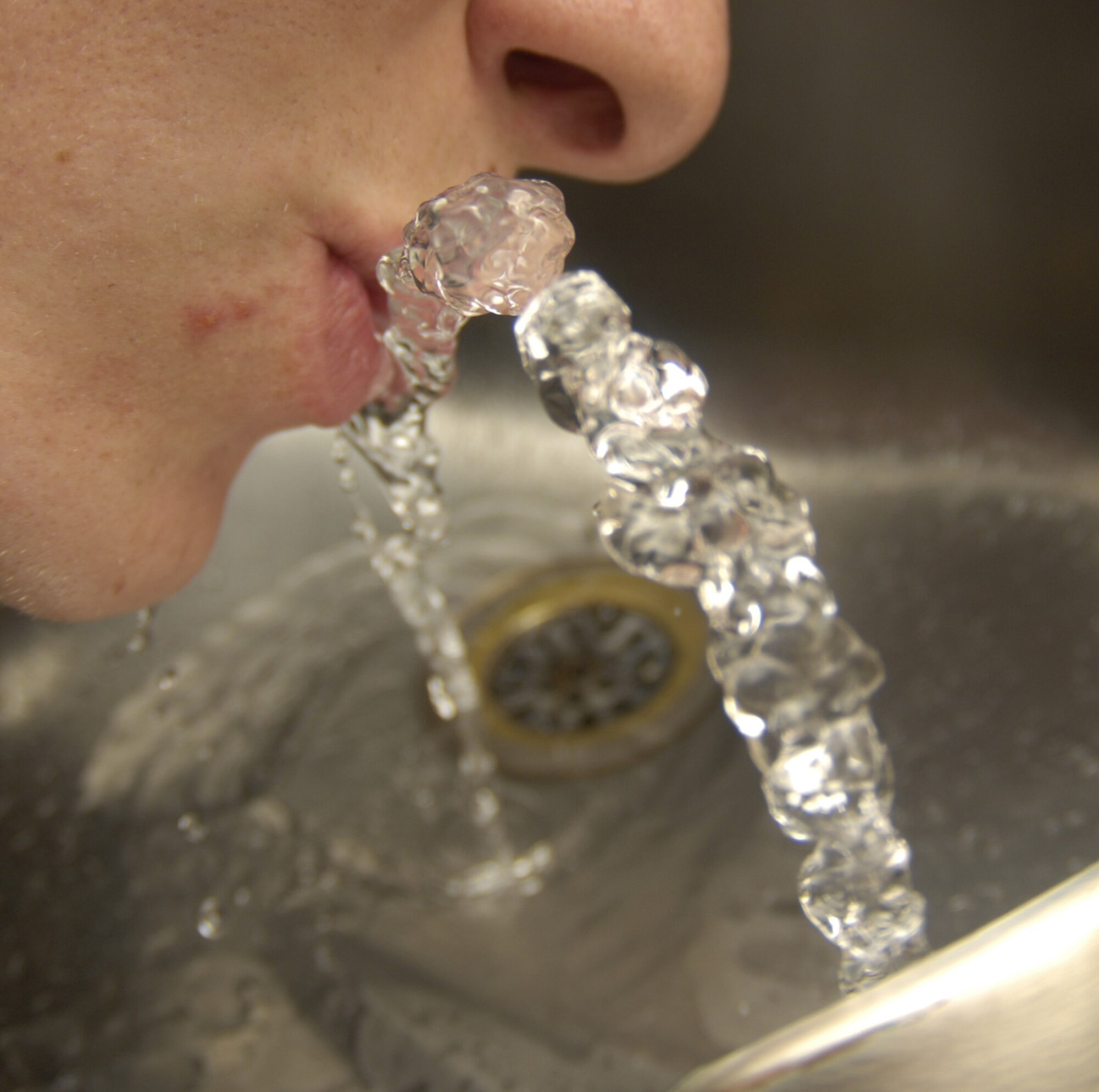 An Airman quenches his thirst July 8 at a Bolling water fountain. Bolling's drinking water has been tested and deemed safe for consumption, meeting all Environmental Protection Agency standards, according to 579th Medical Group Bioenvironmental Engineering Flight officials. (U.S. Air Force photo by Airman 1st Class Sean Adams)
