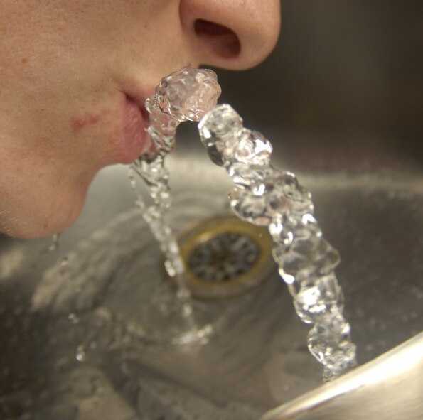 An Airman quenches his thirst July 8 at a Bolling water fountain. Bolling's drinking water has been tested and deemed safe for consumption, meeting all Environmental Protection Agency standards, according to 579th Medical Group Bioenvironmental Engineering Flight officials. (U.S. Air Force photo by Airman 1st Class Sean Adams)
