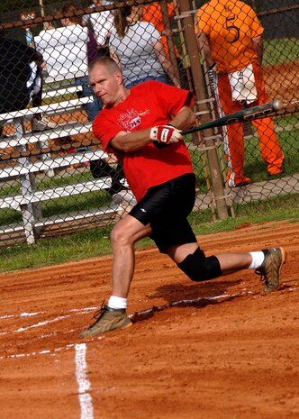 Rodney Rutz hits a ball out to left field during a game at the base softball field July 7. The Flyers beat the Medical Group by forfeiture during intramural softball playoffs which began this week. Rutz is with the 16th Airlift Squadron and played for the Flyers. (U.S. Air Force photo/Airman 1st Class Timothy Taylor)