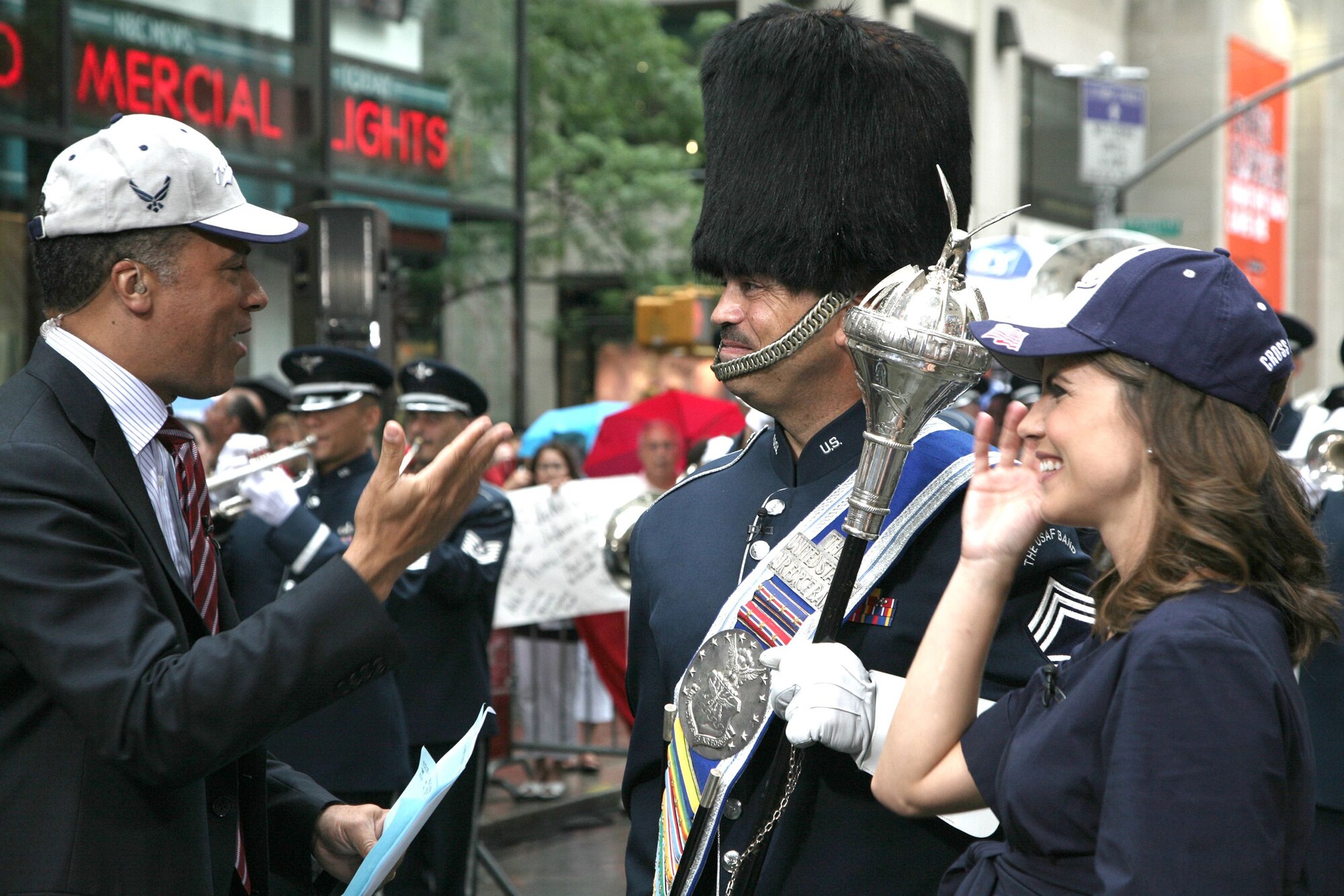 "Today" show hosts Lester Holt and Natalie Morales interview Chief Master Sgt. Ed Teleky, drum major and NCO in charge of the U.S. Air Force Band's Ceremonial Brass, July 4 during a live broadcast from Rockefeller Plaza in New York. The Ceremonial Brass has performed annually on the Today show since 1998. Both Holt and Morales are children of career Airmen. (U.S. Air Force photo by Senior Master Sgt. Robert S. Mesite)
