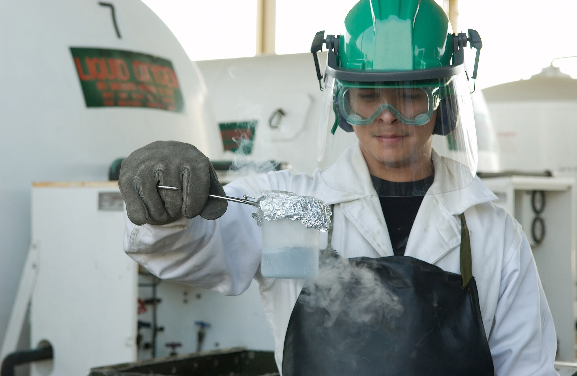 SrA Joshua Westfall with the 436th Logistics Readiness Squadron takes samples of liquid oxygen before being loaded onto a trailer. (U.S. Air Force Photo / Jason Minto)