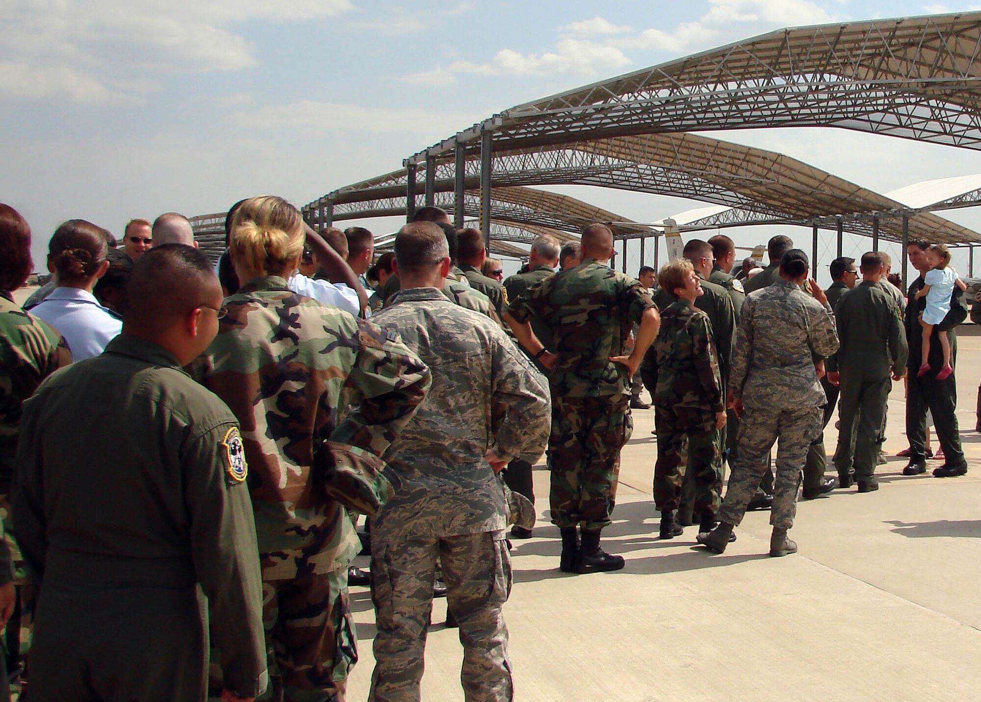 The men and women of Vance AFB, Okla., lineup to congratulate Col. Richard A. Klumpp Jr., commander of the 71st Flying Training Wing at Vance, after his T-1A Jayhawk fini flight, June 30. His next assignment will be chief of staff for the Joint Functional Component Command for Integrated Missile Defense at Schriever AFB, Colo. (U.S. Air Force photo)