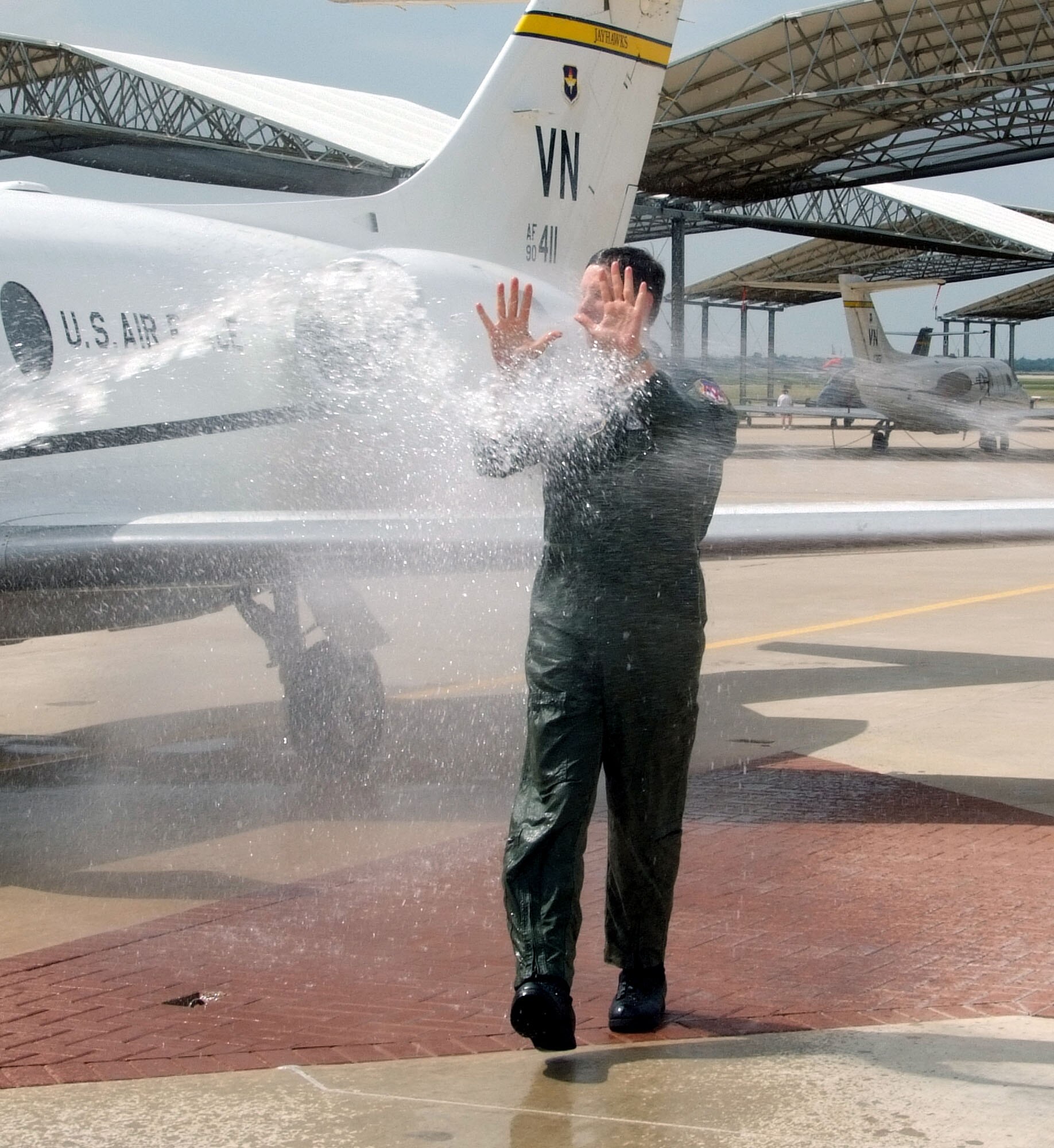 Col. Richard A. Klumpp Jr., commander of the 71st Flying Training Wing at Vance AFB, Okla., is sprayed down by family and friends at the end of his T-1A Jayhawk fini flight June 30. Colonel Klumpp will hand over command of the 71st FTW to Col. Mark C. Nowland on July 11 and become chief of staff for the Joint Functional Component Command for Integrated Missile Defense at Schriever AFB, Colo. (U.S. Air Force photo by Terry Wasson)