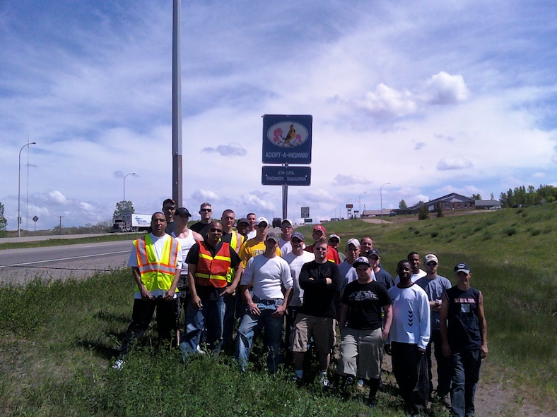 MINOT AIR FORCE BASE, N.D. -- Members of the 5th Civil Engineer Squadron here, pose for a photo after cleaning a two-mile section of highway in Minot. The two-mile stretch of highway is located on Highways 2 and 52 just south of the Highway 83 bypass. The high-volume traffic at that location makes it a settling point for airborne debris. In all, the squadron picked up about 65 to 70 bags of trash. (courtesy photo)