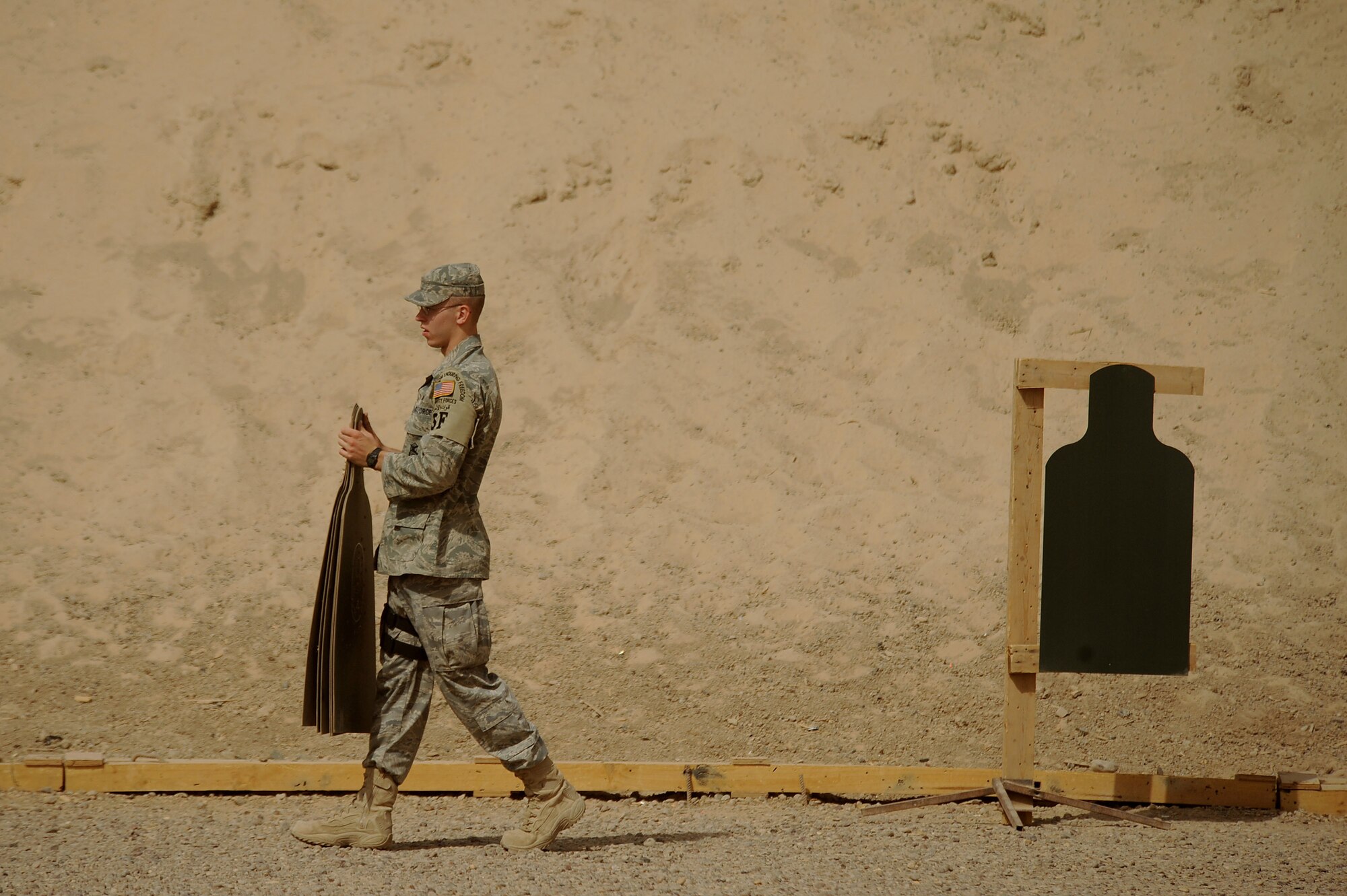 Senior Airman Kyle Brabb sets up targets at a range June 18 near Sather Air Base, Iraq. Airman Brabb is assigned to the 447th Expeditionary Security Forces Squadron deployed from the 109th Air Refueling Wing Security Forces Squadron from Topeka, Kan. (U.S. Air Force photo/Tech. Sgt. Jeffrey Allen) 
