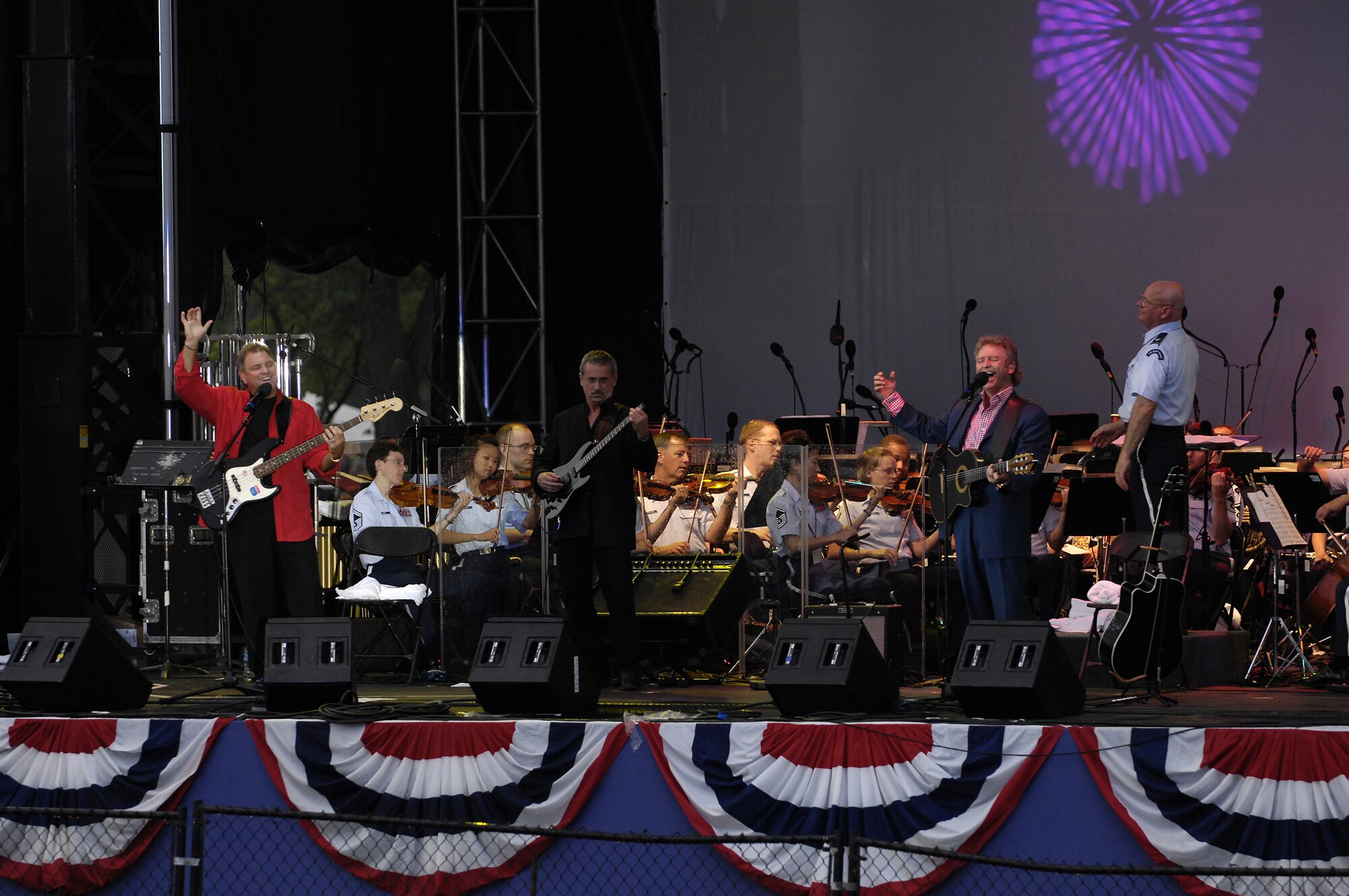 Larry Gatlin and the Gatlin Brothers perform on stage with the U.S. Air Force Band July 4 at the Washington Monument.  The Band presents a special concert open to the public at the base of the Washington Monument as part of the National Park Service's Independence Day Celebration. The program included the Concert Band, the Singing Sergeants, Max Impact and a special appearance by the Grammy Award-winning country artists Larry Gatlin and the Gatlin Brothers. (U.S. Air Force photo by Senior Airman Marleah Miller)