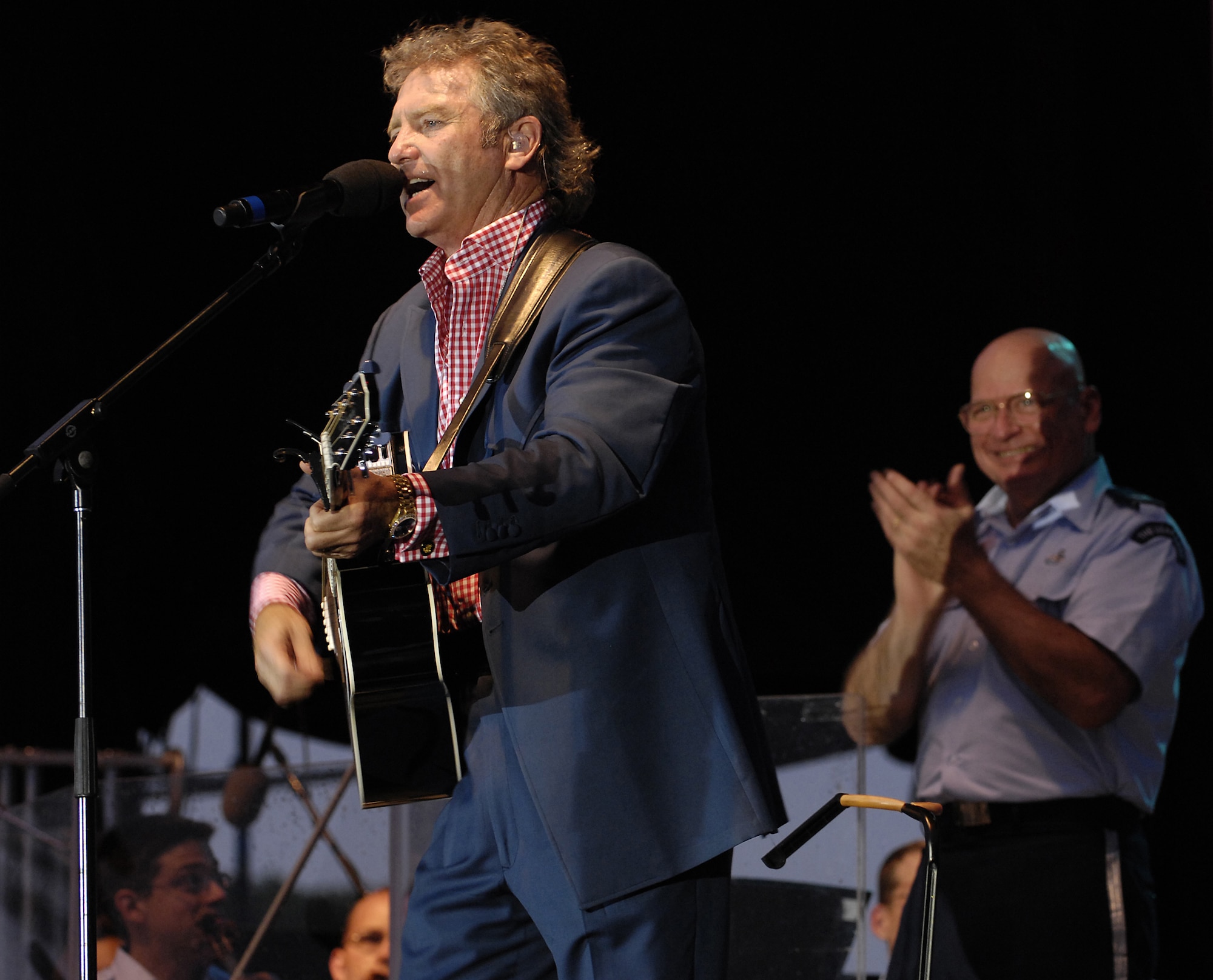 Larry Gatlin performs on stage with the U. S. Air Force Band July 4 at the Washington Monument. The Band presents a special concert open to the public at the base of the Washington Monument as part of the National Park Service's Independence Day Celebration. The program included the Concert Band, the Singing Sergeants, Max Impact and a special appearance by the Grammy Award-winning country artists Larry Gatlin and the Gatlin Brothers. (U.S. Air Force photo by Senior Airman Marleah Miller)