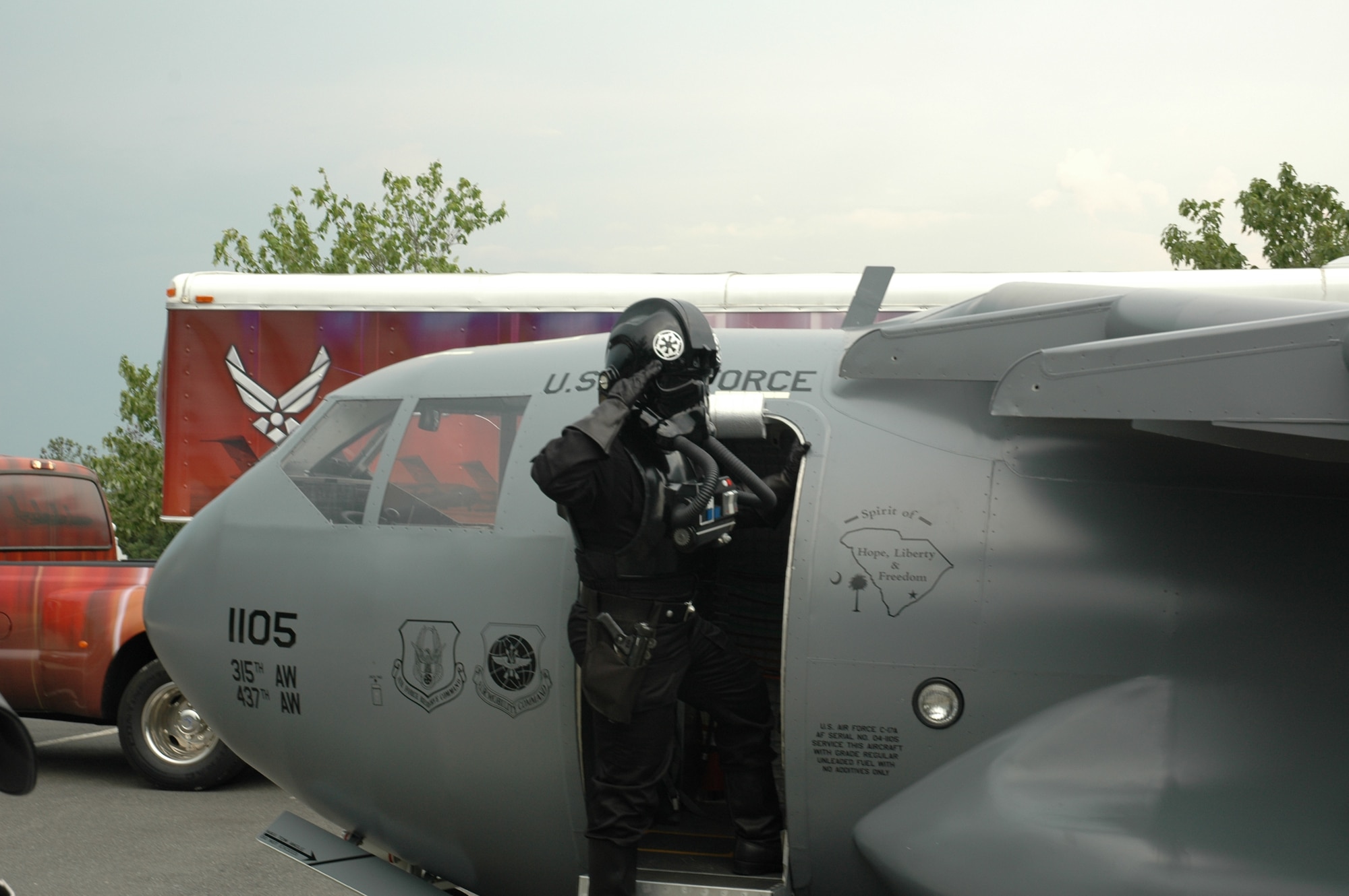 A  Tega Cay, S.C., resident dressed as a storm-trooper, a character from the Star Wars movie series, salutes at the steps of the Mini C-17 during the city’s 26th anniversary celebration July 4 at the new Philip Glennon Community Center.  (photo by 2nd Lt. Holly Carlisle, USAFR)