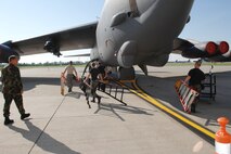 MINOT AIR FORCE BASE, N.D. -- 5th Aircraft Maintenance Squadron weapons load crew 28 prepare to load a GBU-38 bomb onto a B-52H Stratofortress during a weapons loading competition here June 30. Each load crew team consists of four Airmen who are evaluated every month on how well they load different types of weapons. (U.S. Air Force photo by Senior Airman Cassandra Jones)