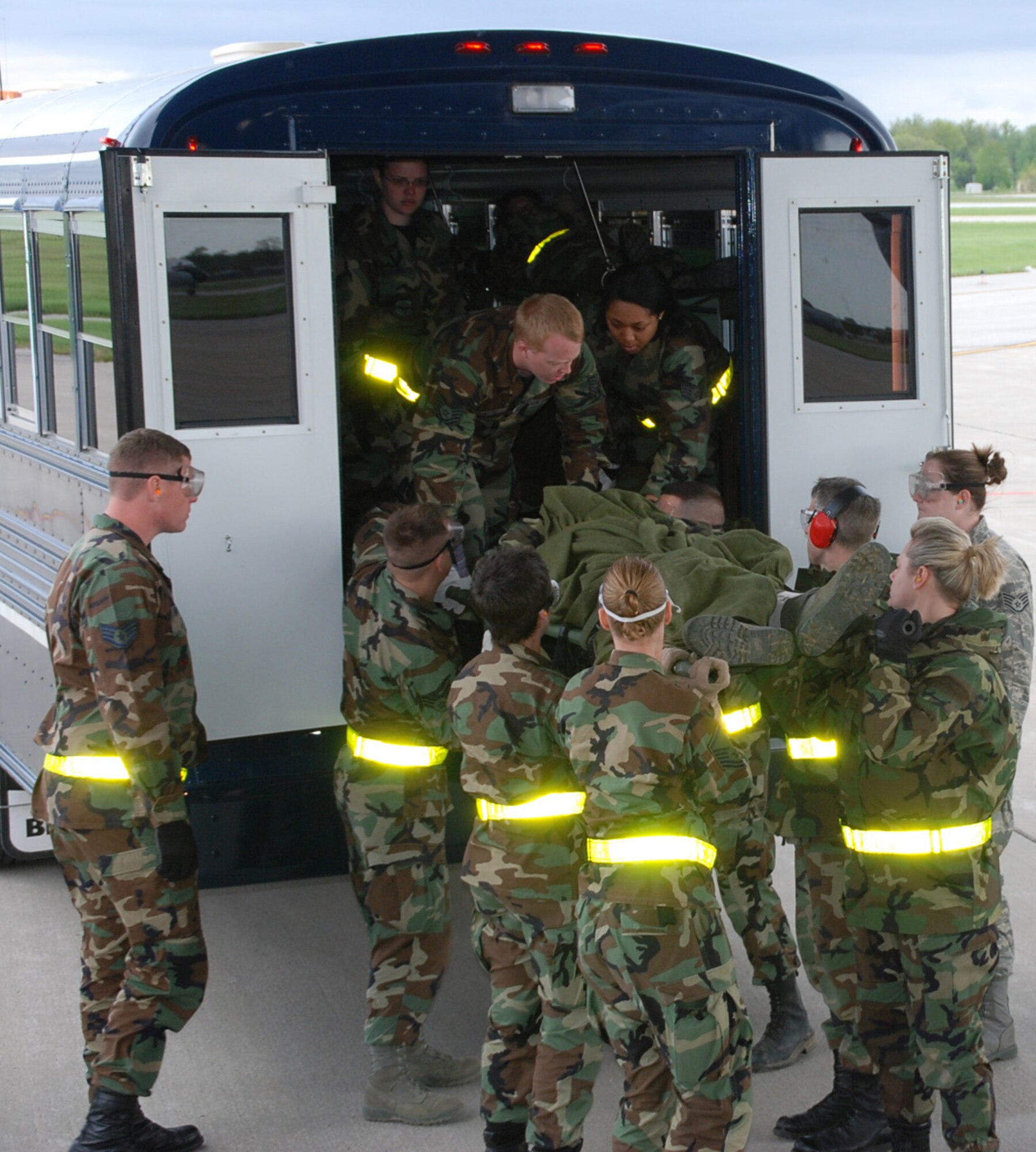 Medical specialists from the 932nd Airlift Wing load up simulated patients on a bus for transportation.  During a four-day unit training assembly event, various members from the medical and aeromedical fields of expertise gathered at the wing to practice.  They improved their skills in diagnosing injuries and working the triage process to prioritize the most serious patients and get them to emergency help first.
Patients were taken care of throughout the process and eventually loaded onto
a waiting aircraft just as in a war situation.  Photo/Tech. Sgt. Dan Oliver