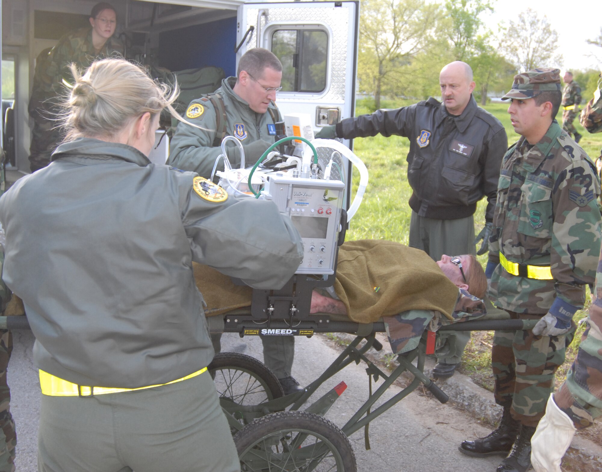Members of the 932nd Medical Group unload a simulated patient from an ambulance during the four-day exercise.  During the assembly, various members
from the medical and aeromedical fields of expertise gathered at the wing to
practice their life-saving skills and to deal with various challenges of logistics and time management.

They improved their skills in diagnosing injuries and working the triage process to
prioritize the most serious patients and get them to emergency help first.
Patients were taken care of throughout the process and eventually loaded onto
a waiting aircraft just as in a war situation.  Photo/Tech. Sgt. Dan Oliver